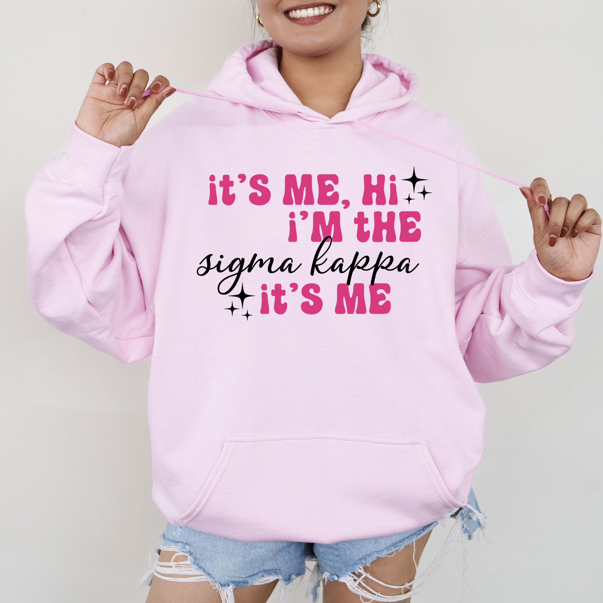 a woman wearing a pink hoodie that says it's me, i '