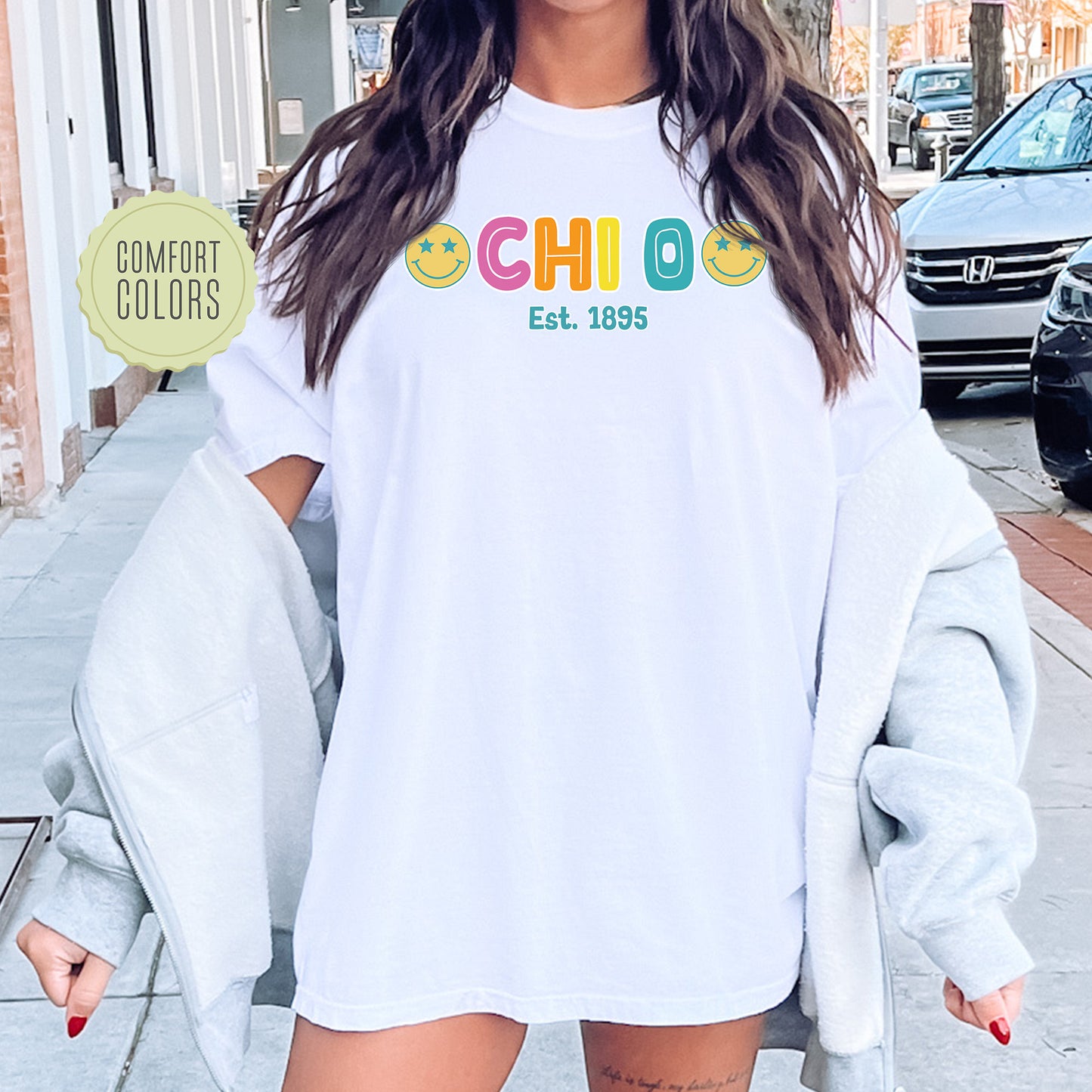 a woman wearing a white shirt with the word chilo on it