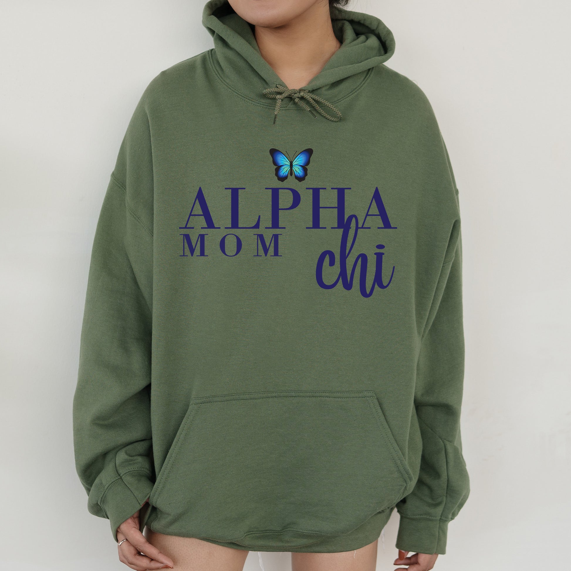 a woman wearing a green hoodie with a blue butterfly on it