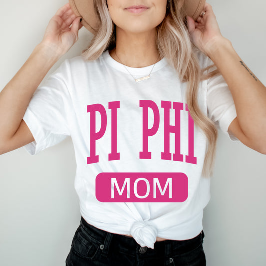 a woman wearing a pink phi mom shirt