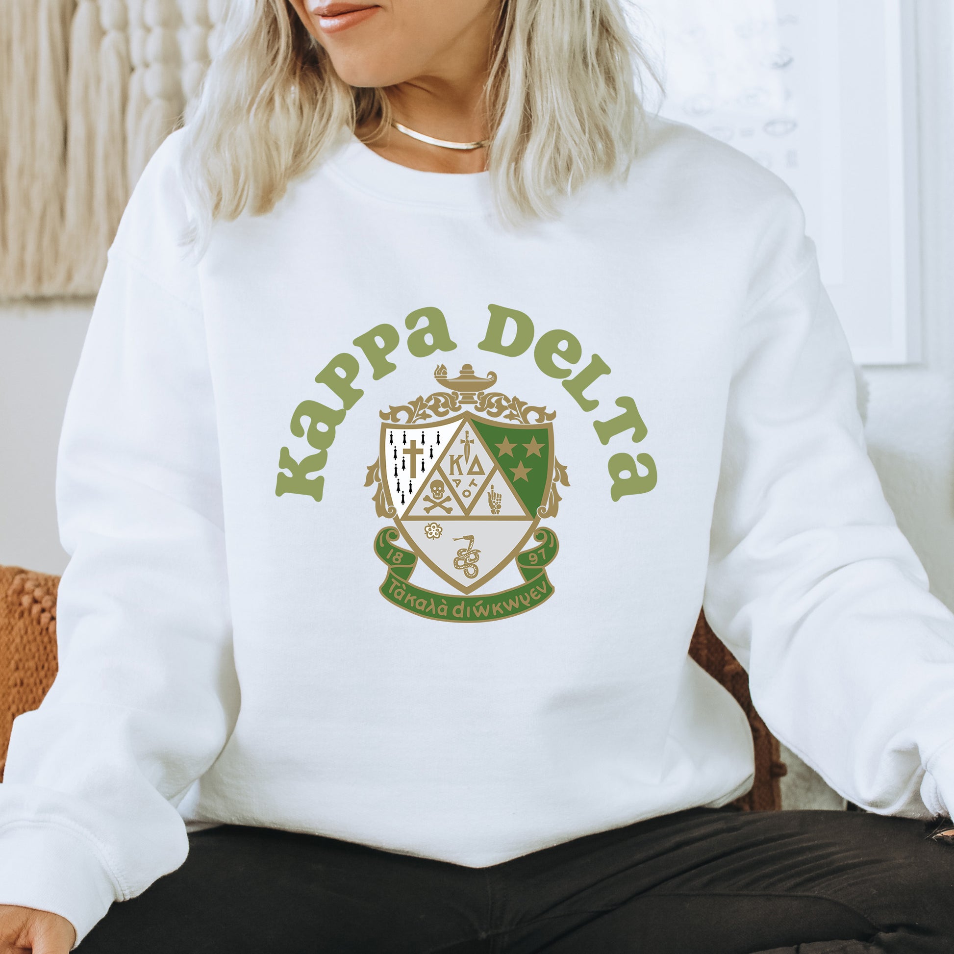 a woman sitting on a chair wearing a white sweatshirt