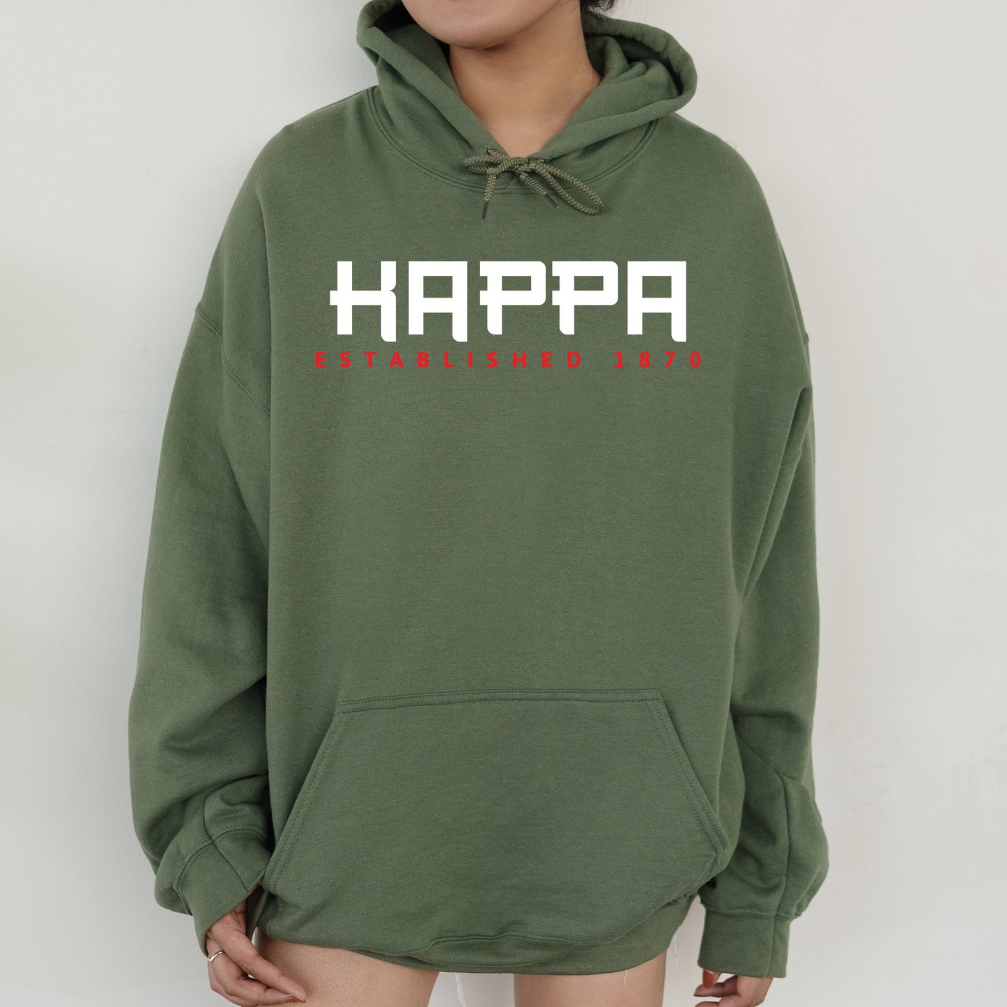 a person wearing a green hoodie with the words happy on it
