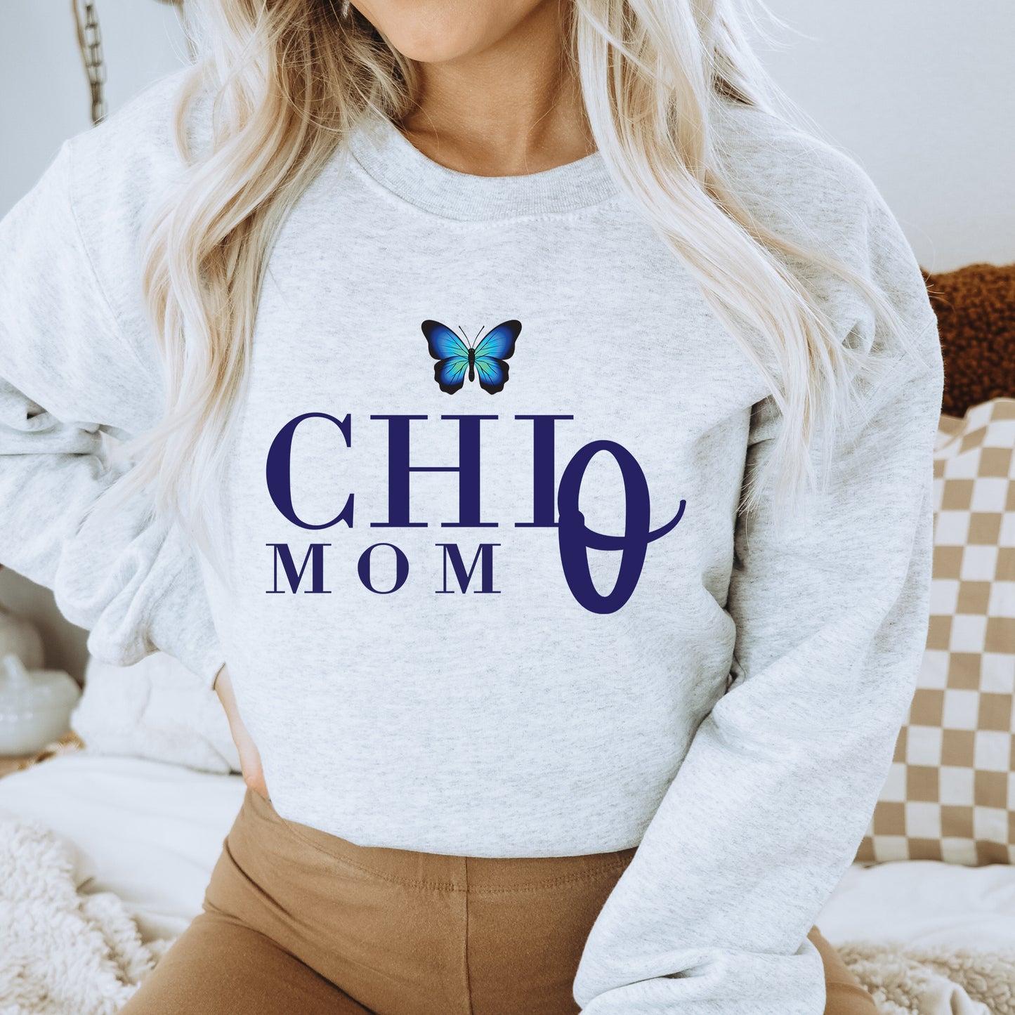 a woman wearing a sweatshirt with a butterfly on it