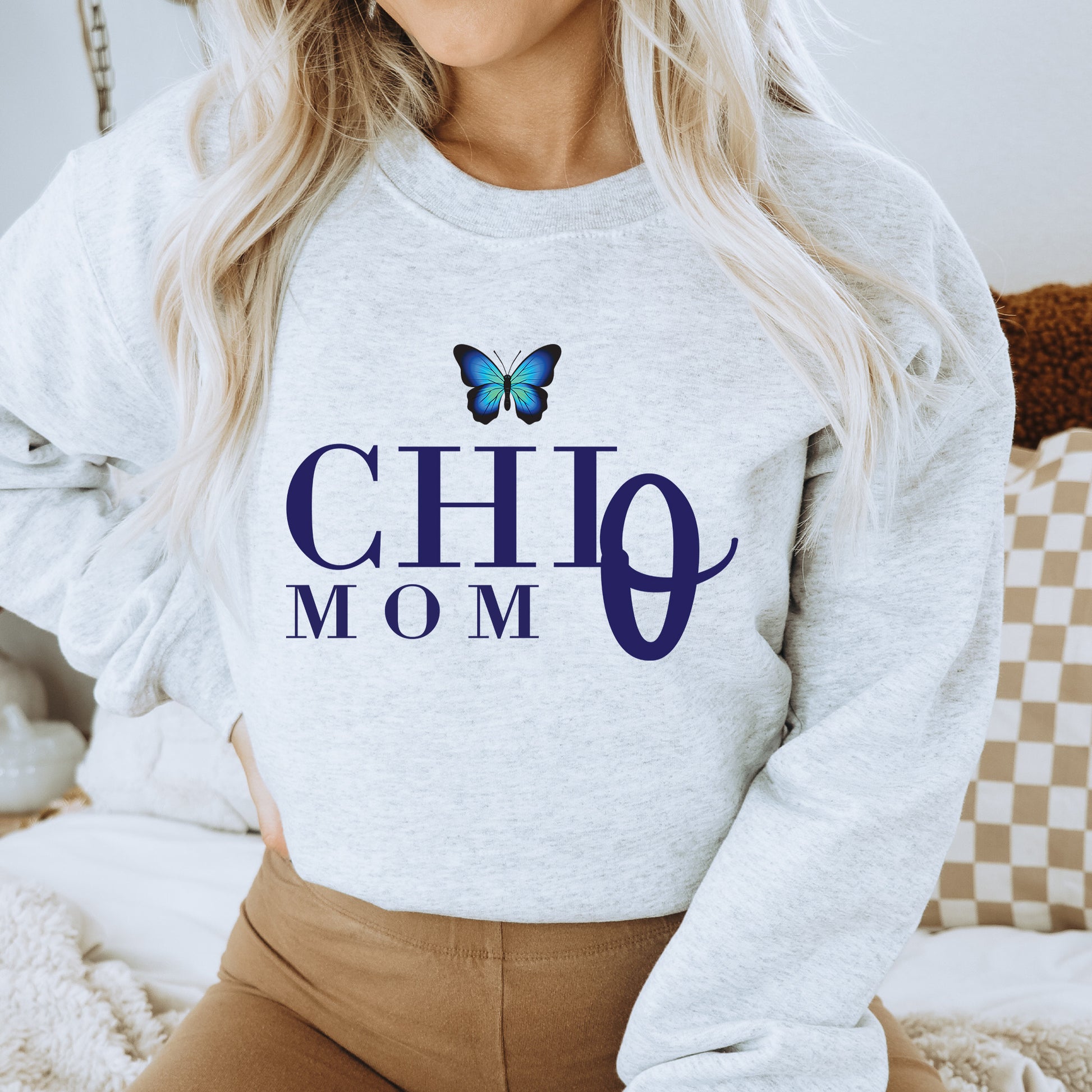 a woman wearing a sweatshirt with a butterfly on it