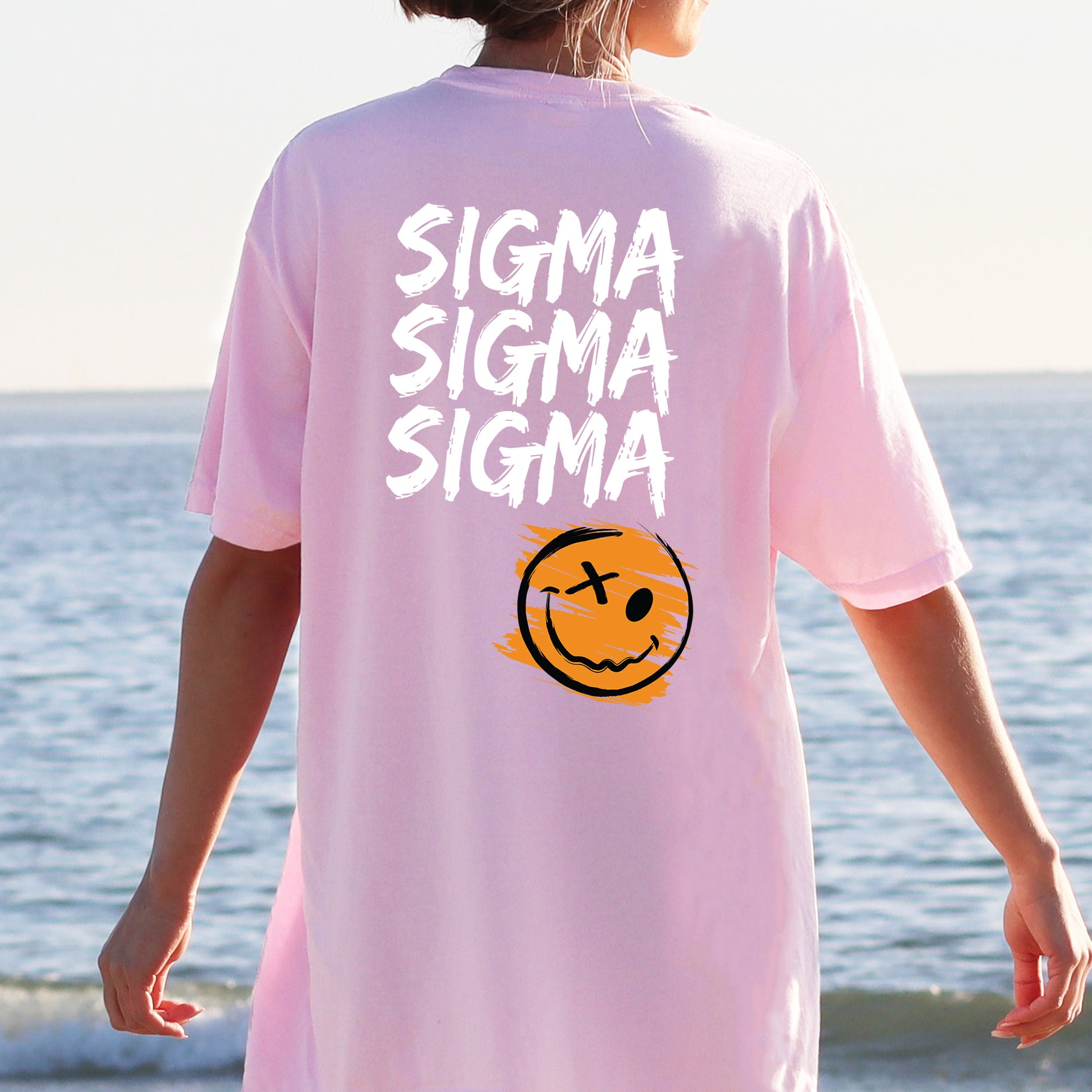a person wearing a pink shirt with a smiley face on it