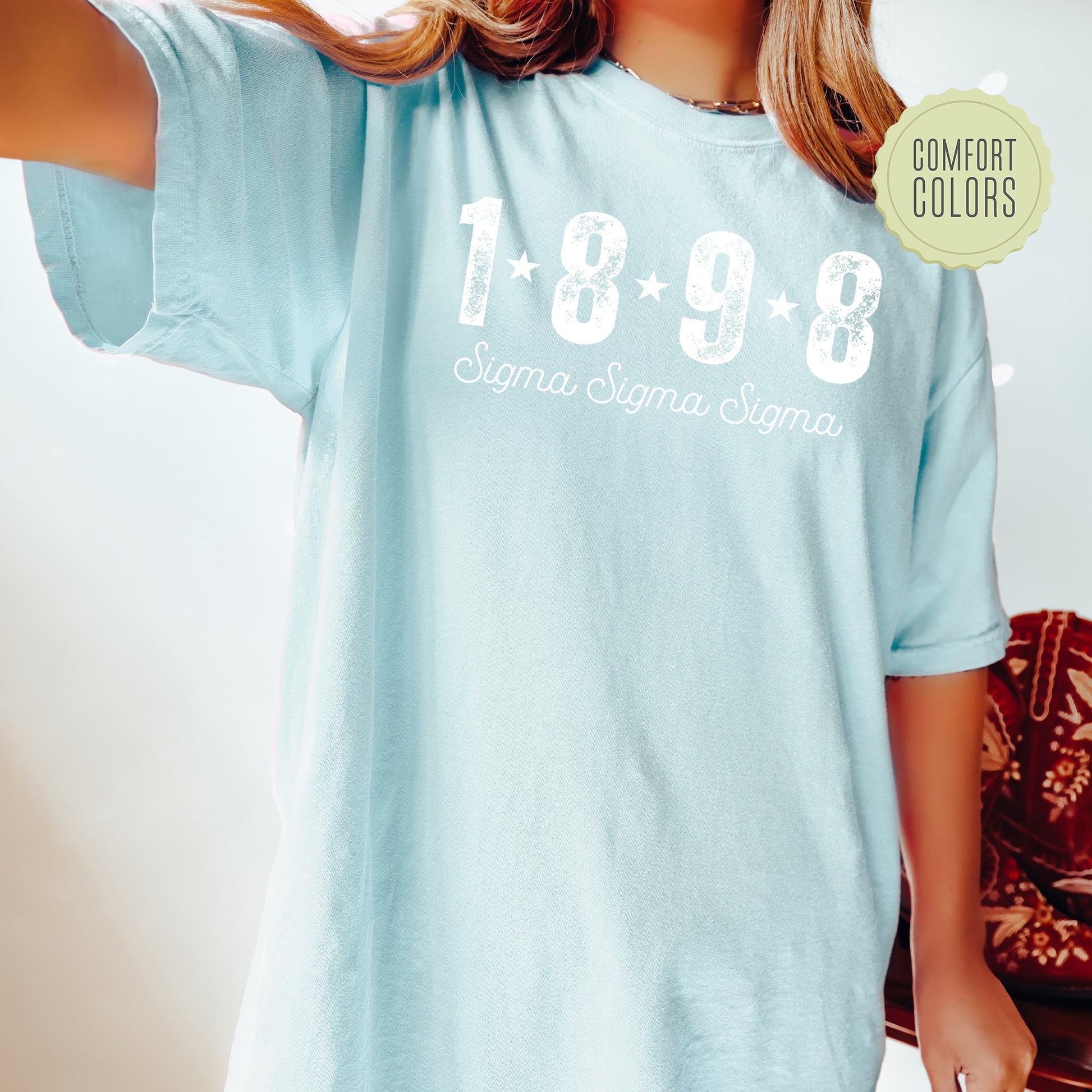a woman wearing a light blue shirt with the words 1989 printed on it