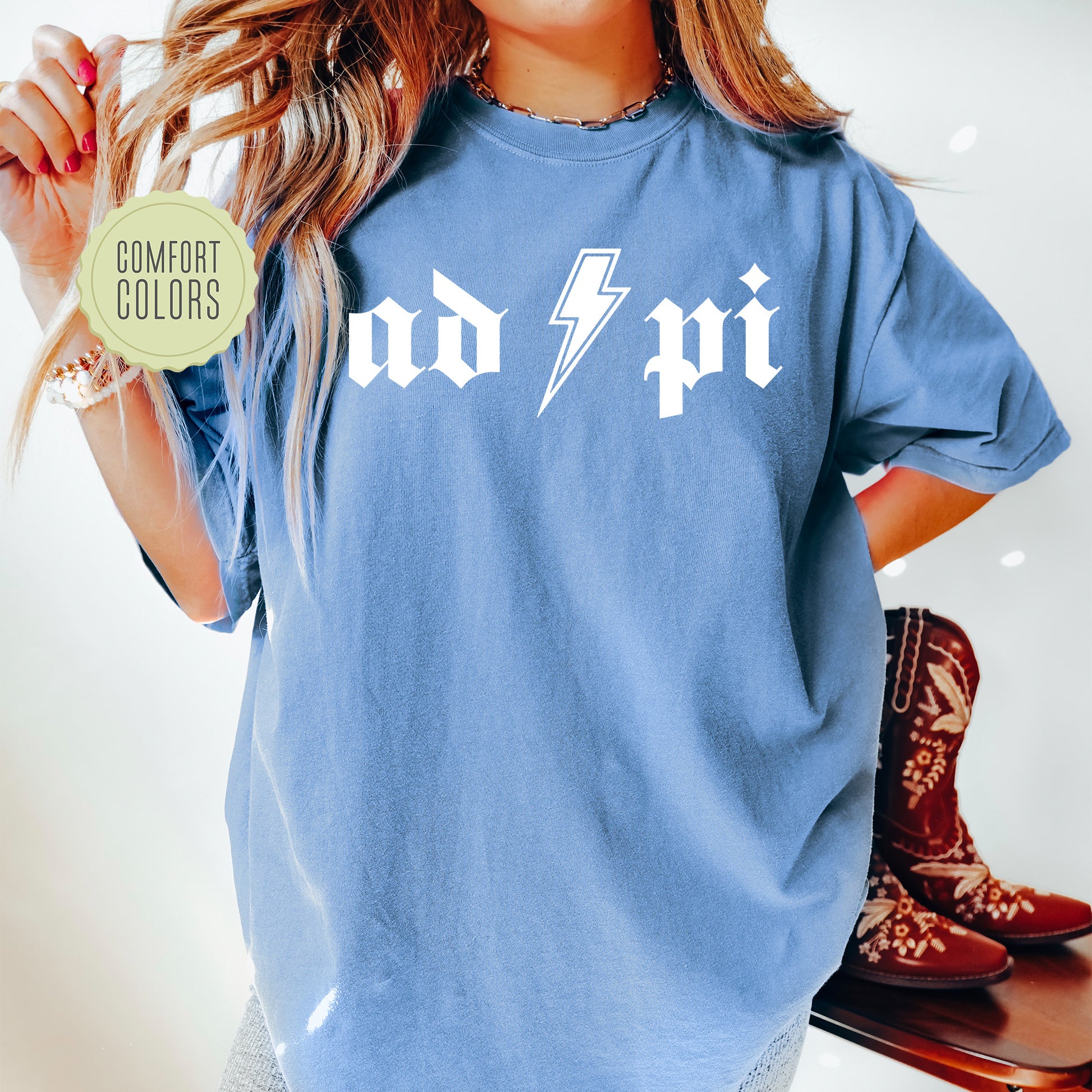 a woman wearing a blue shirt with a lightning bolt on it