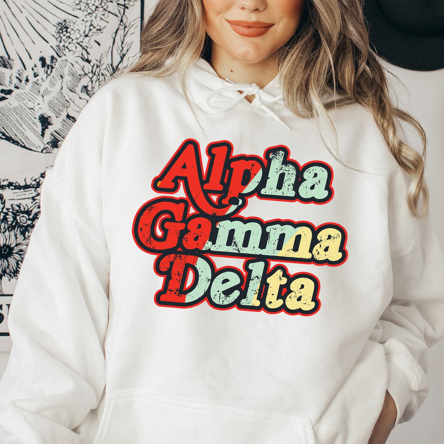 a woman wearing a white hoodie that says ah aha damn delta