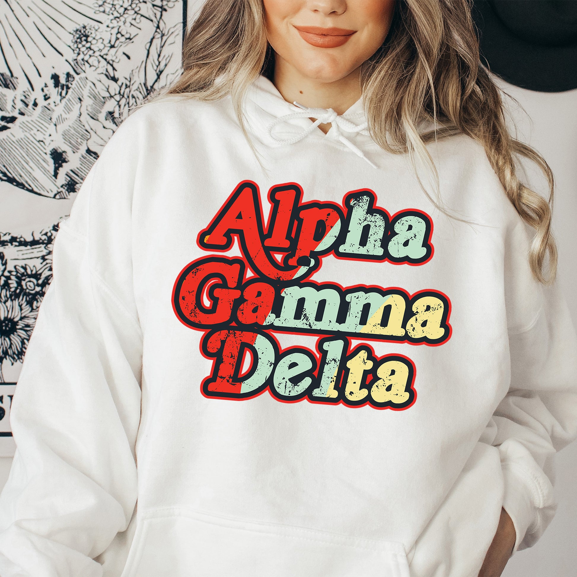 a woman wearing a white hoodie that says ah aha damn delta