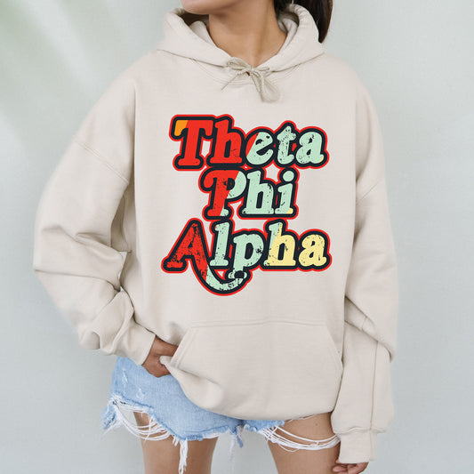 a woman wearing a white hoodie that says thea phi phi aha