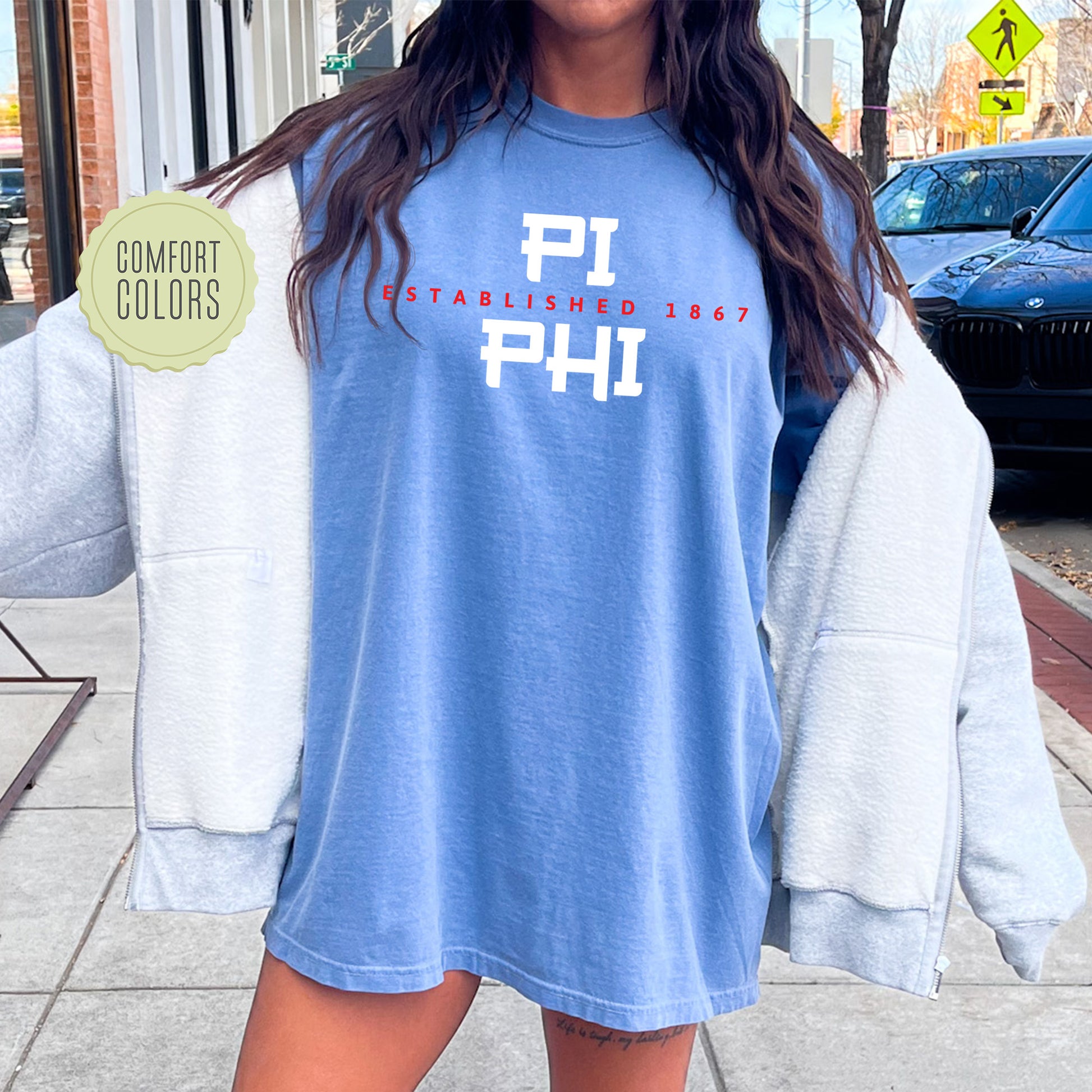 a woman standing on a sidewalk with a blue shirt