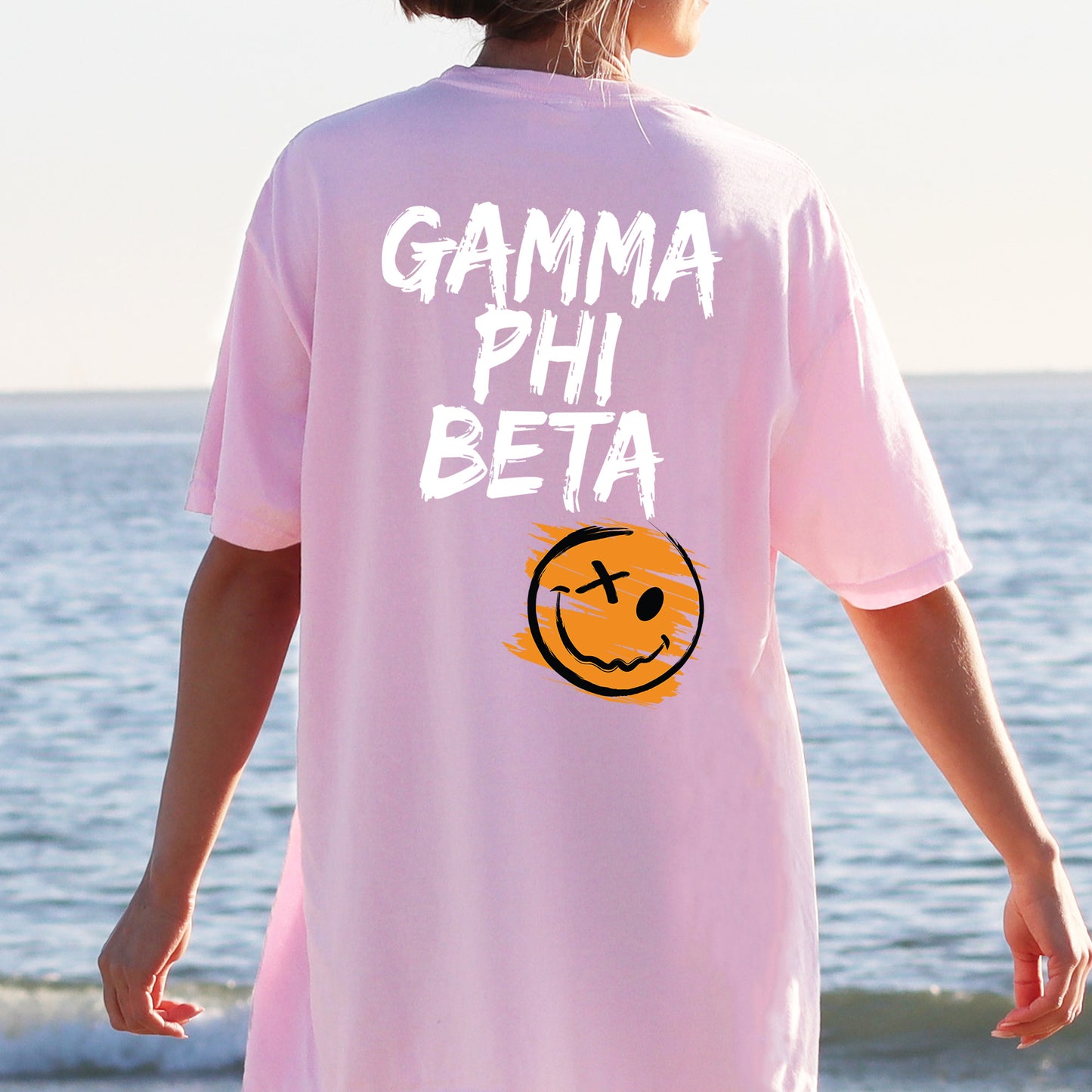 a person wearing a pink shirt with a smiley face on it