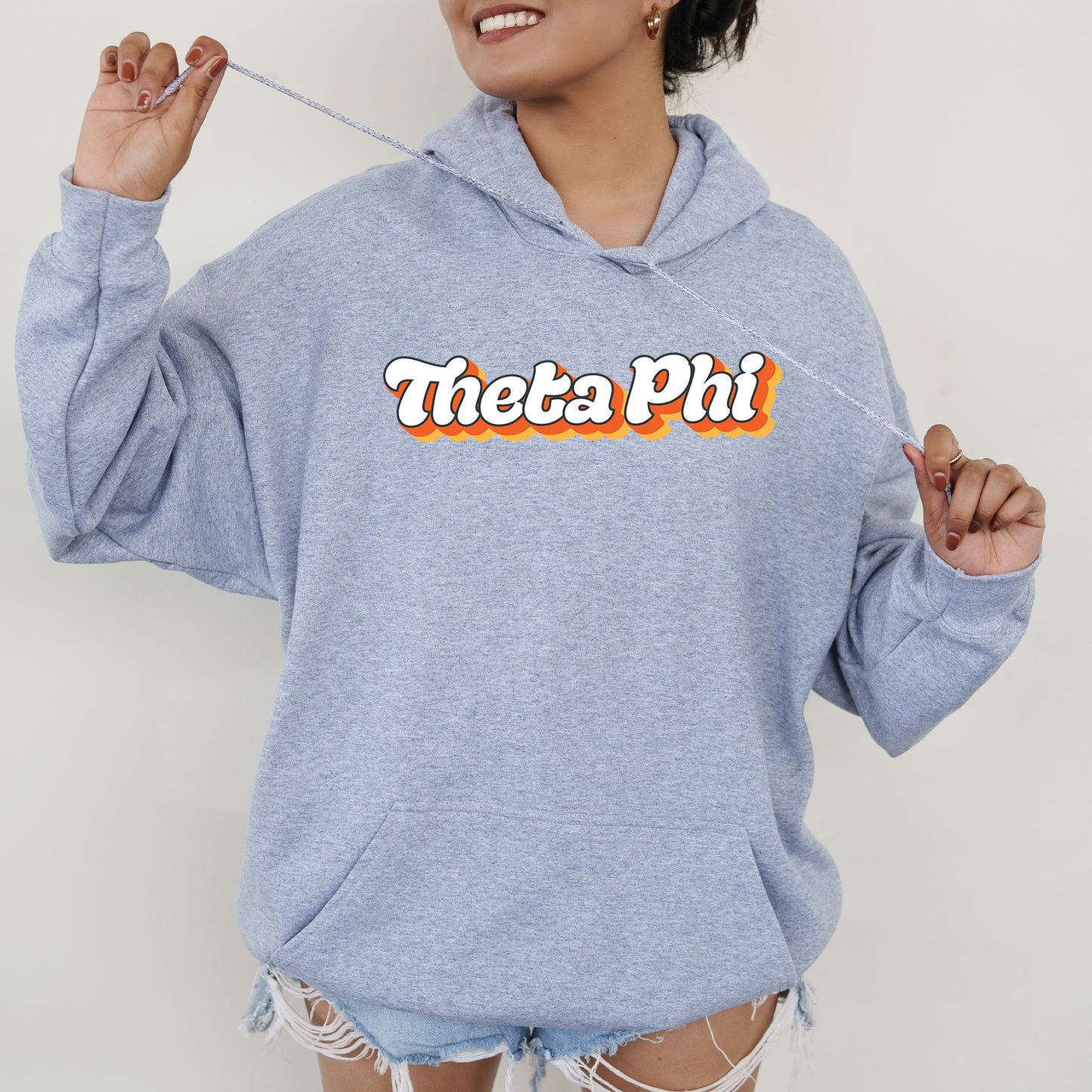 a woman in a blue hoodie holding a toothbrush