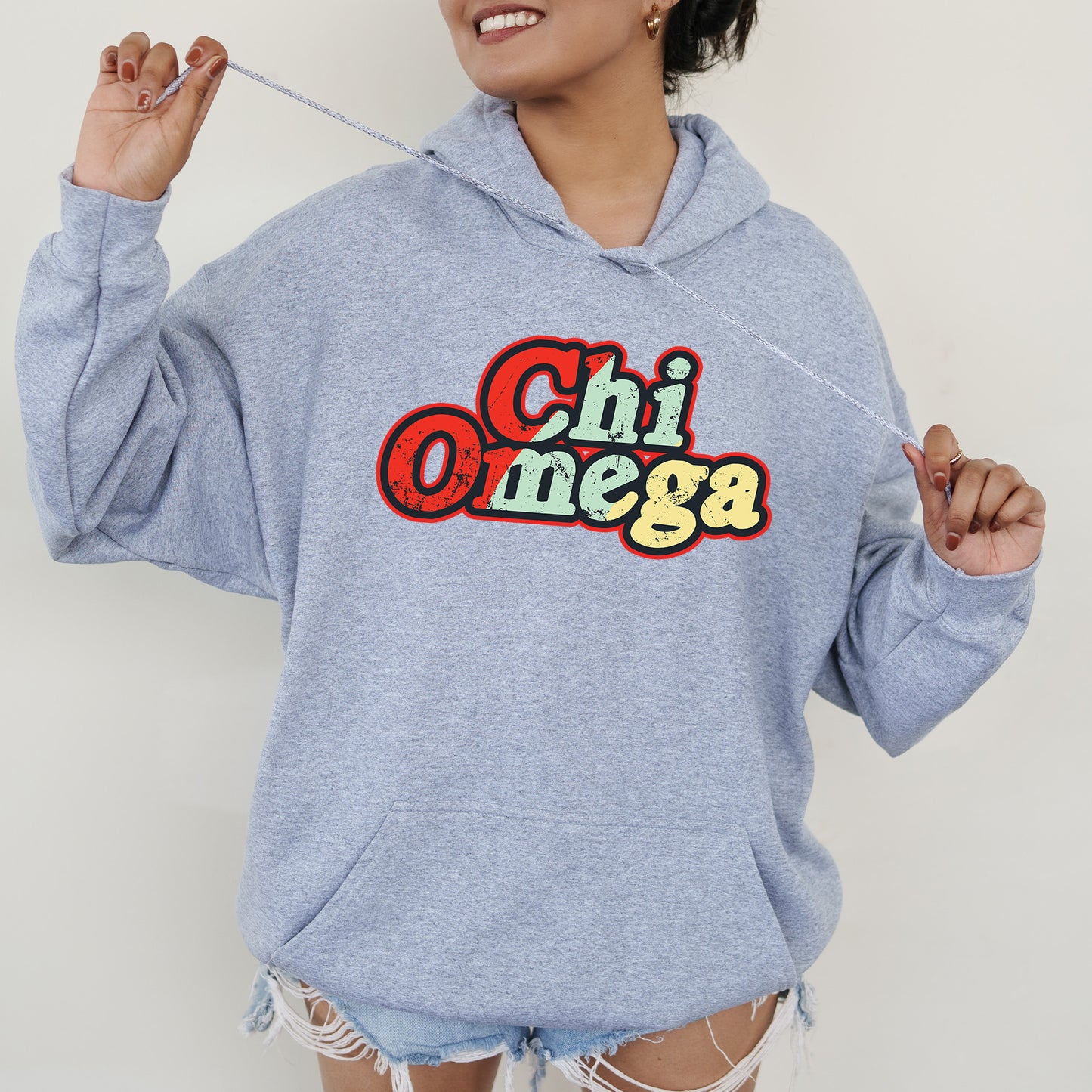 a woman in a blue hoodie holding a toothbrush