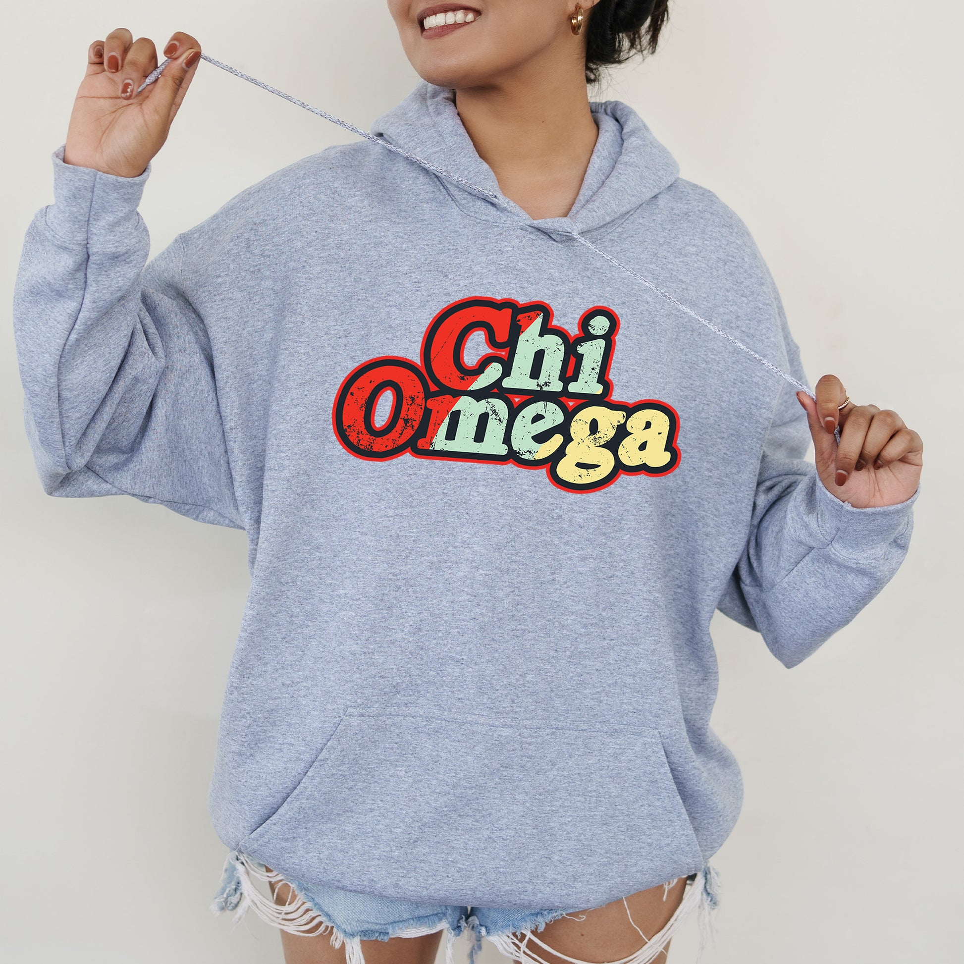 a woman in a blue hoodie holding a toothbrush