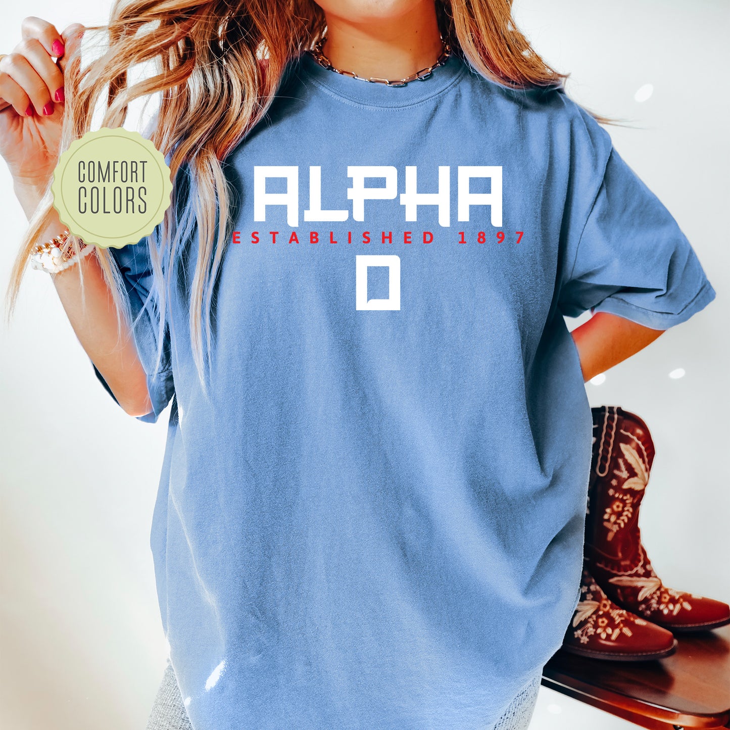 a woman wearing a blue shirt with the word alphia on it