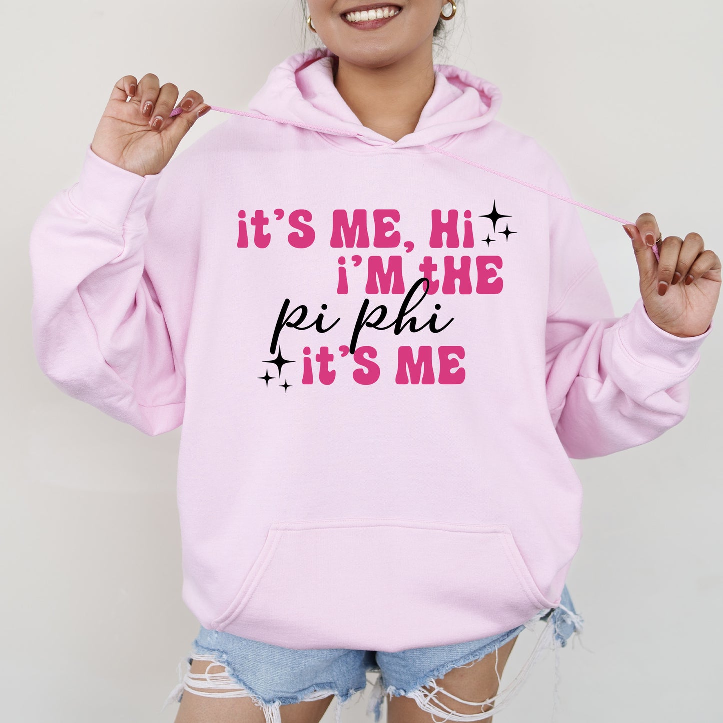 a woman wearing a pink hoodie that says it's me, i '