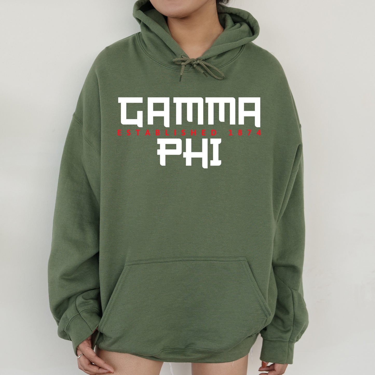 a person wearing a green hoodie with the words garma phi printed on it