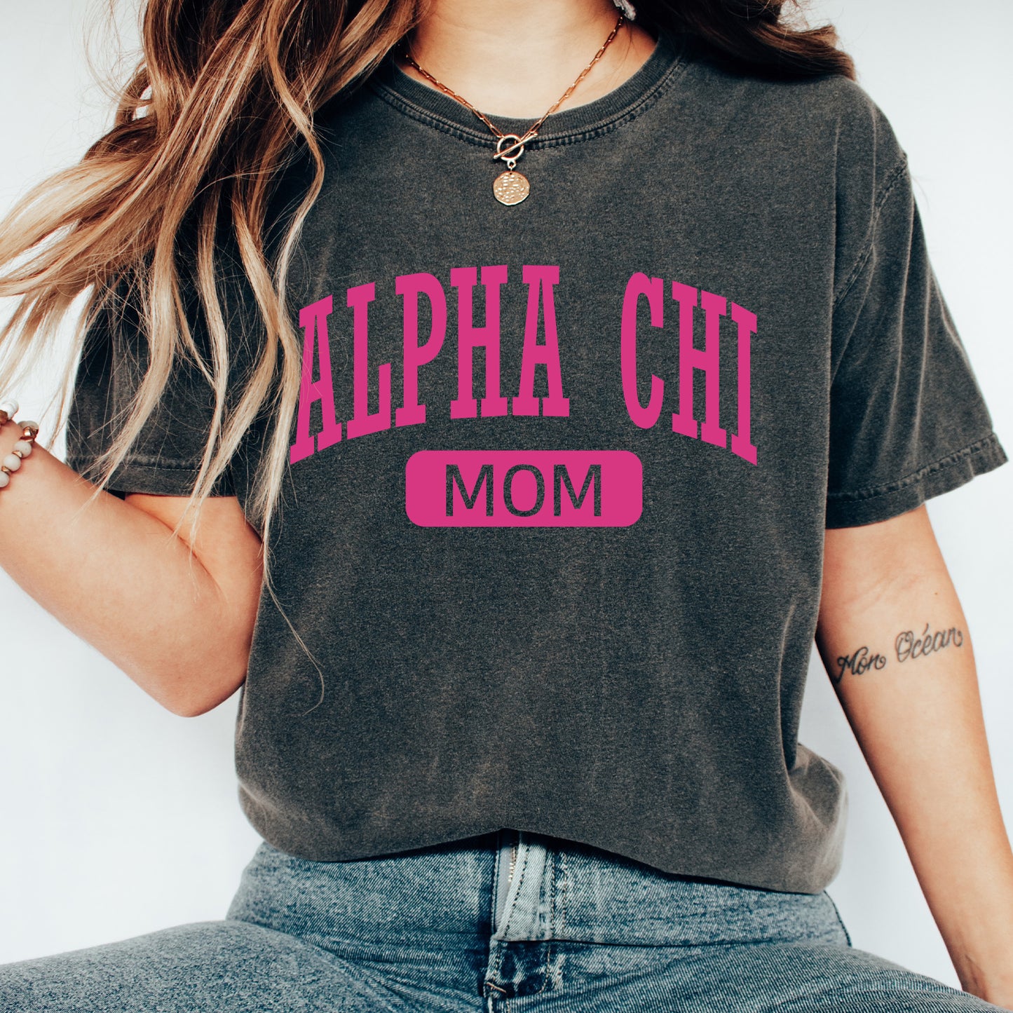 a woman wearing a black shirt with pink letters on it