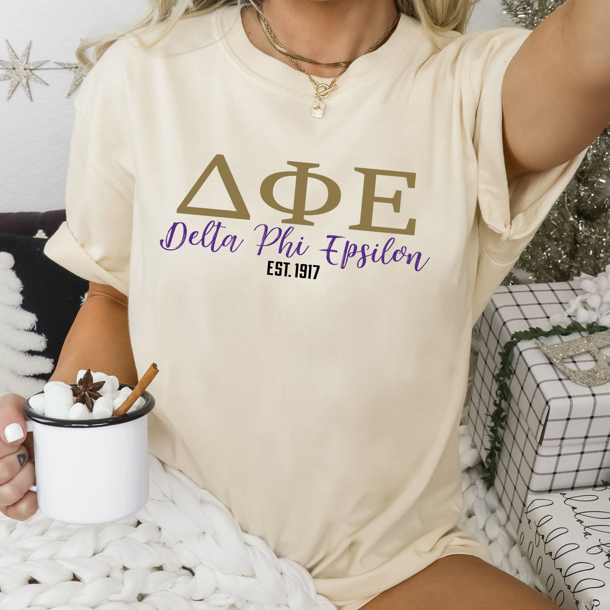 a woman sitting on a bed holding a cup of coffee