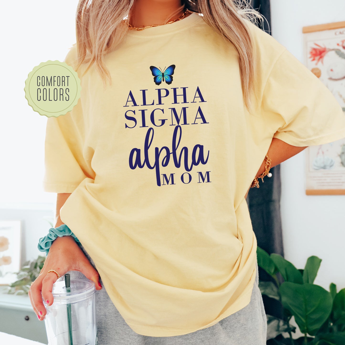 a woman wearing a yellow shirt with a butterfly on it