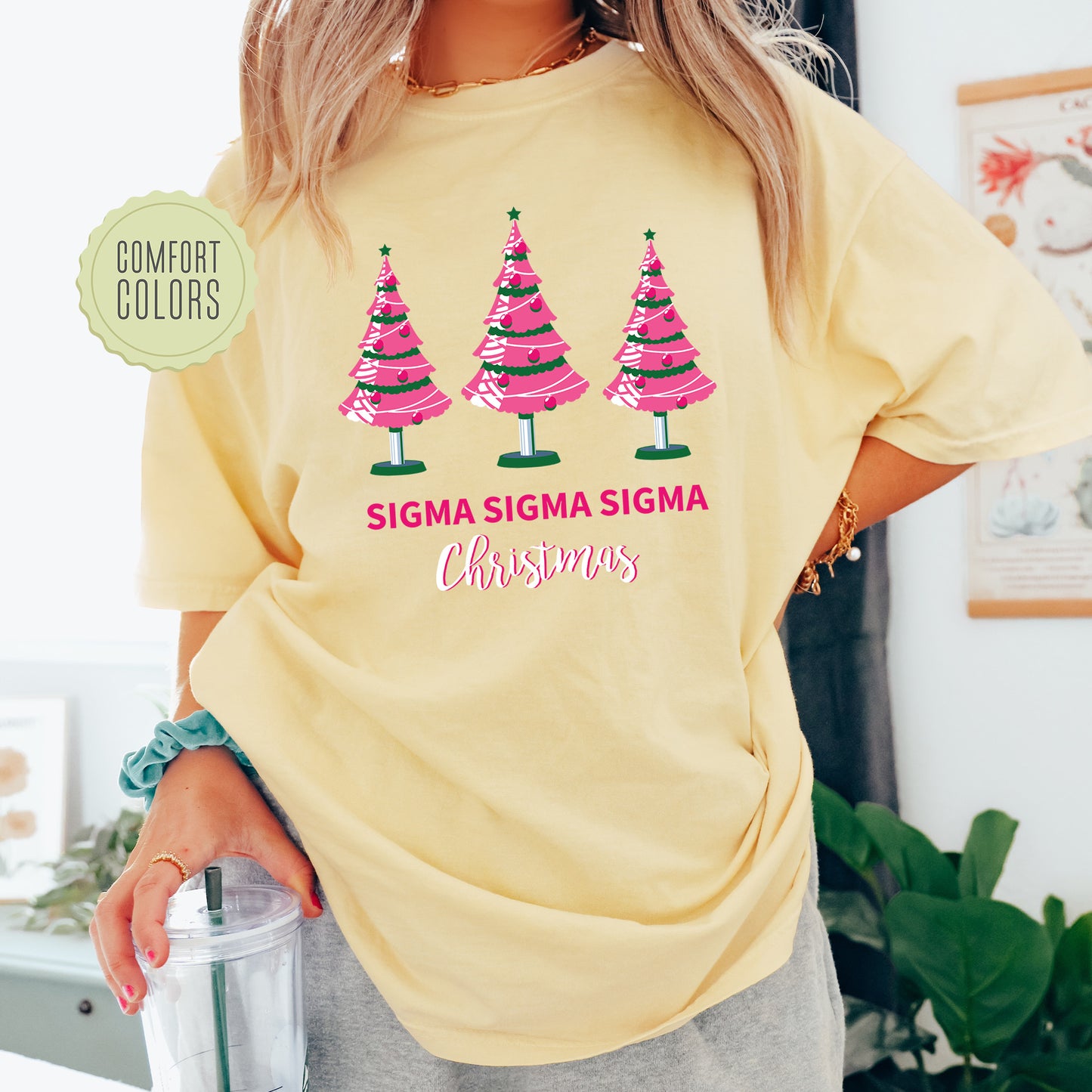 a woman wearing a yellow shirt with christmas trees on it
