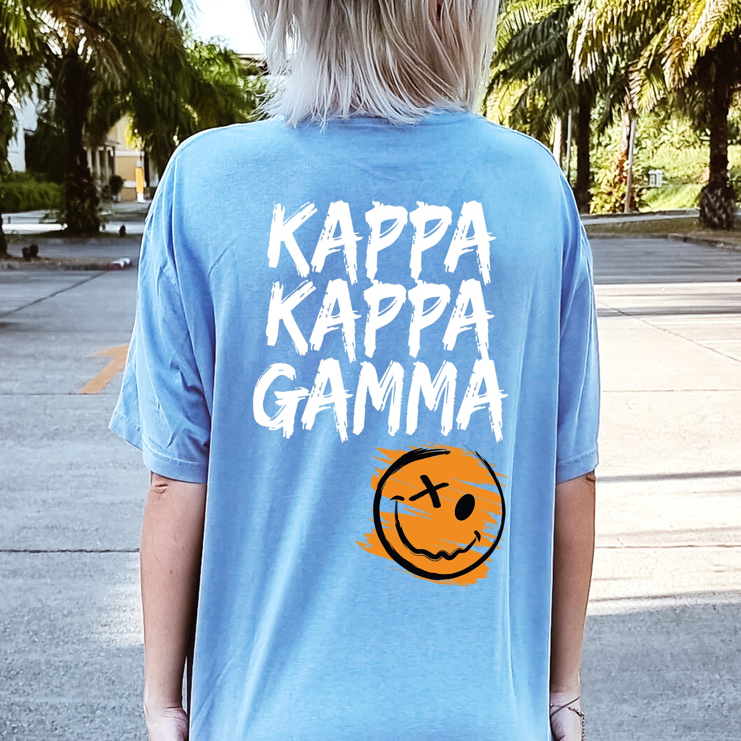 a person wearing a blue shirt that says kappa kappa gamma