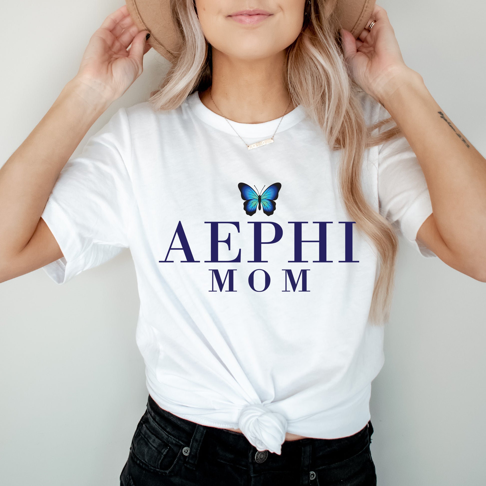 a woman wearing a white shirt with a butterfly on it