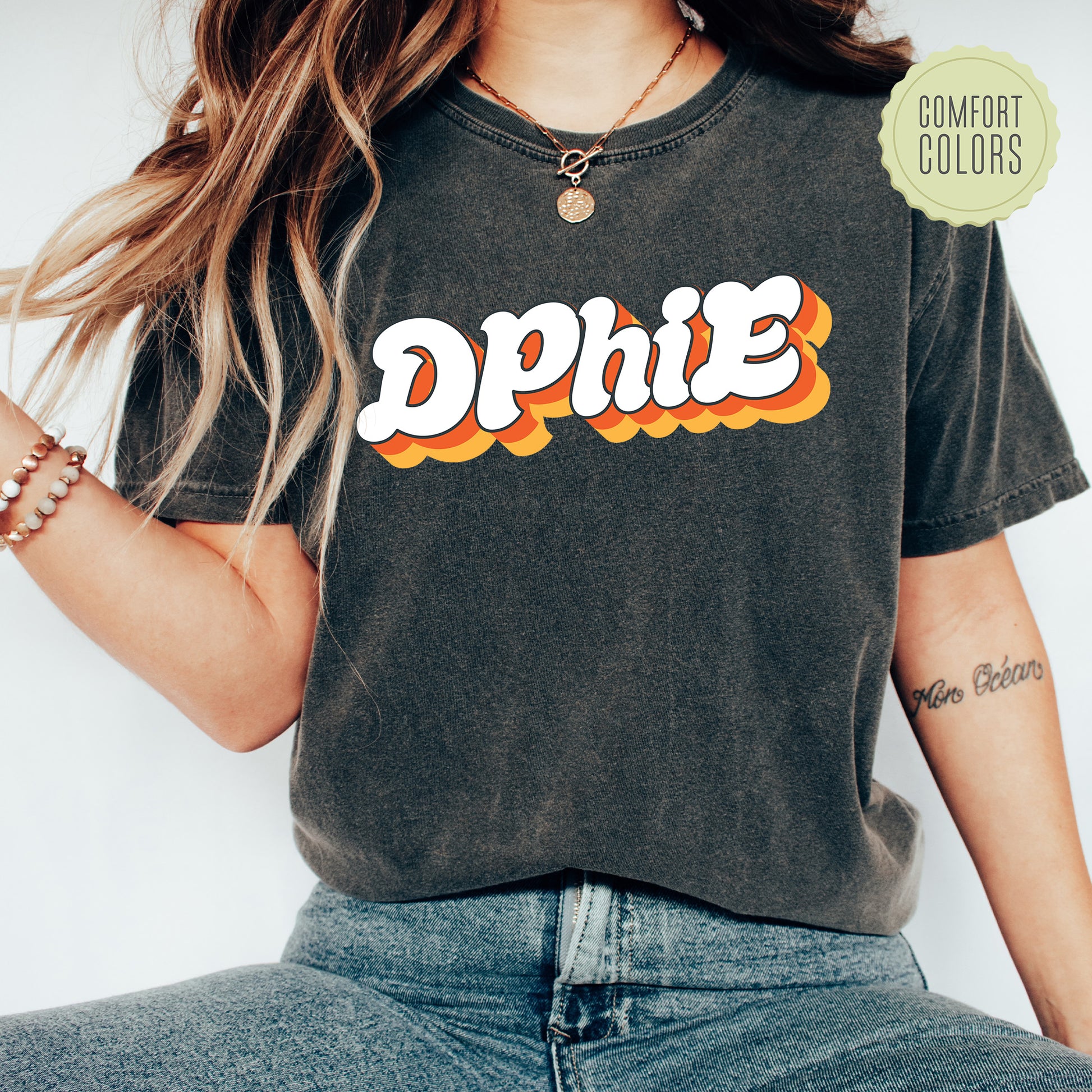 a woman wearing a black shirt with the word phi on it