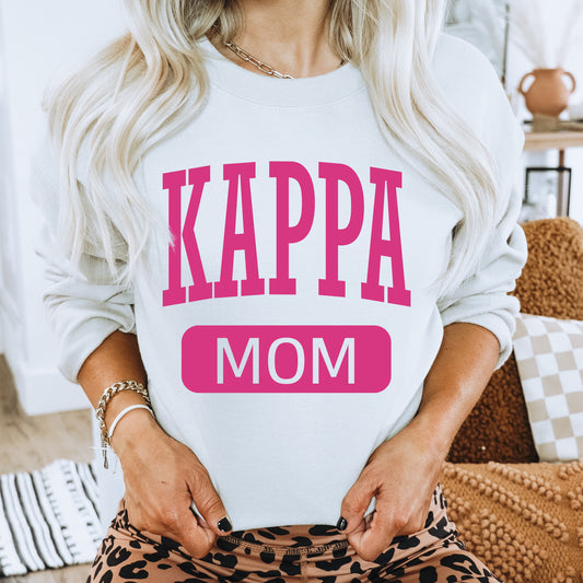 a woman wearing a sweatshirt that says kappa mom