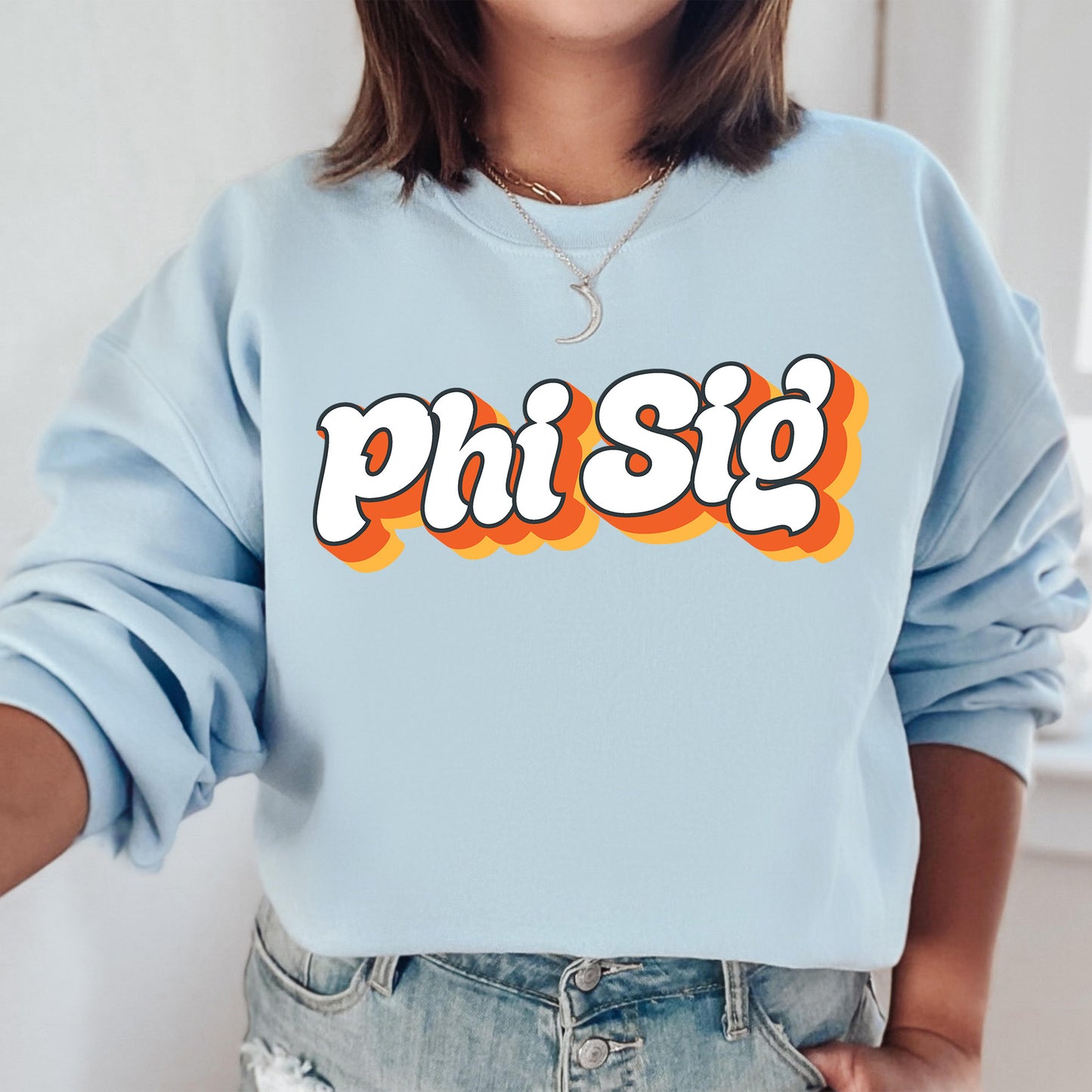 a woman wearing a blue sweatshirt with the word phi si on it