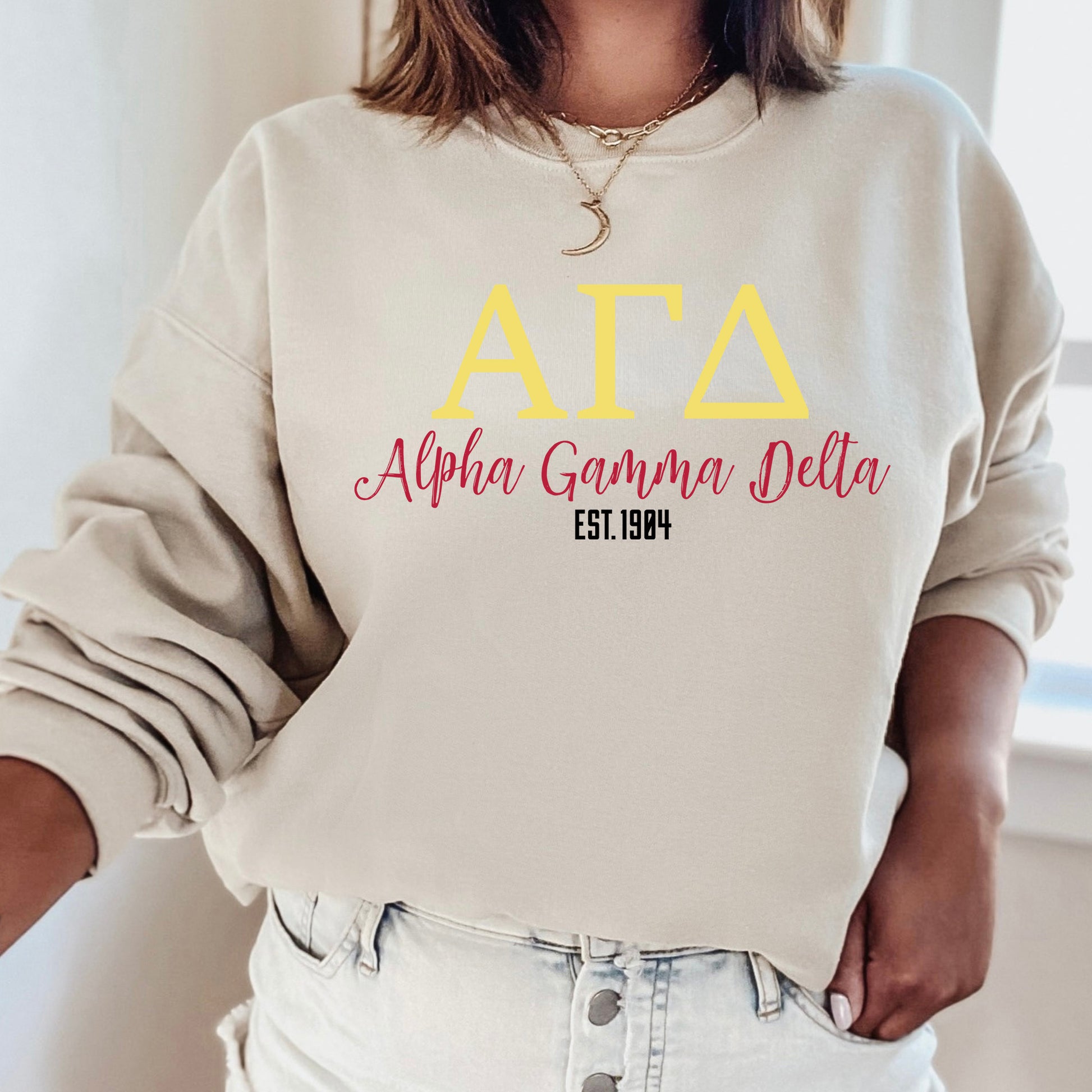 a woman wearing a sweatshirt with the letters ata and a name on it