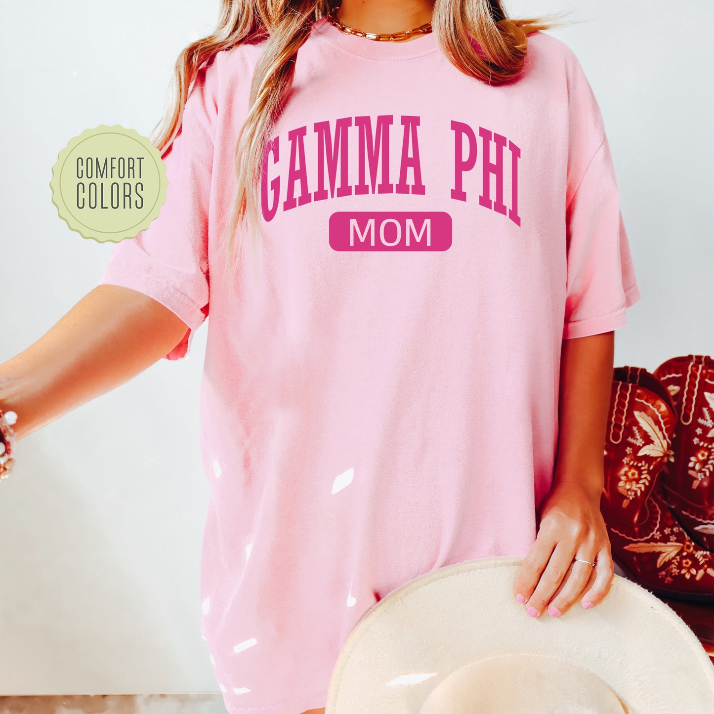 a woman wearing a pink shirt and hat