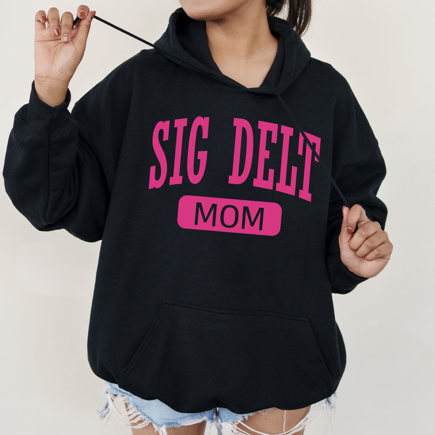 a woman wearing a black sweatshirt with a pink slogan on it