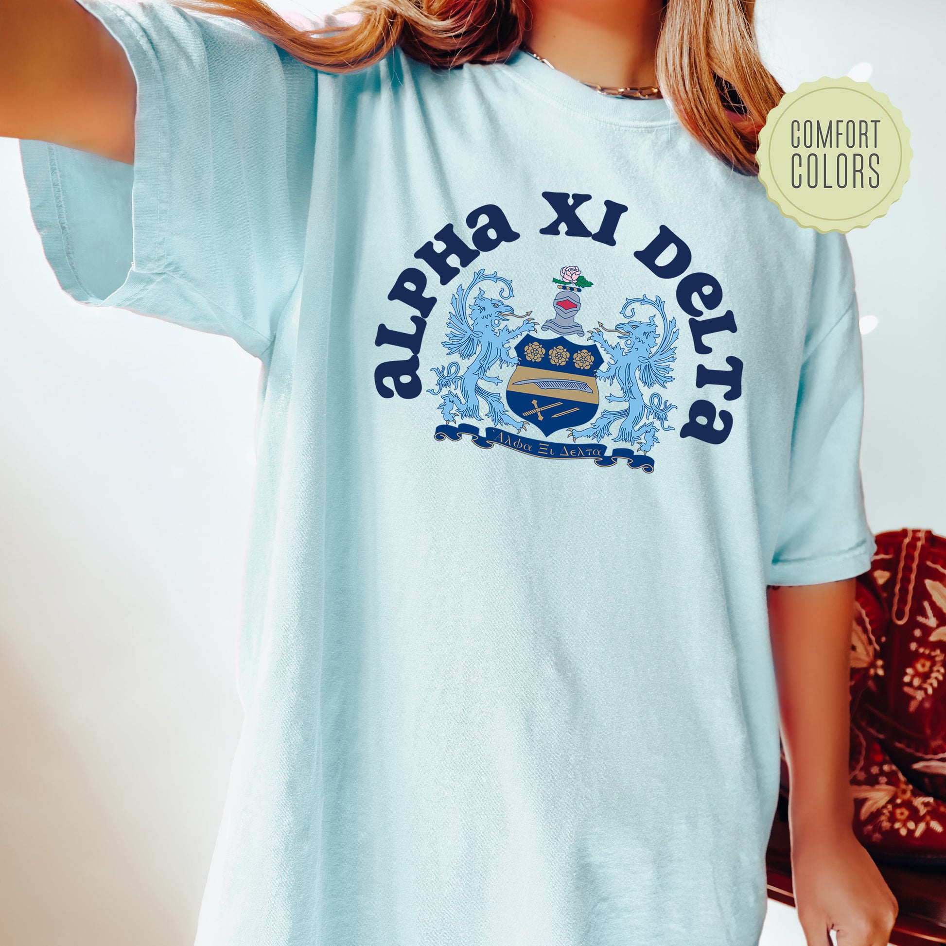 a young girl wearing a blue shirt with a crest on it