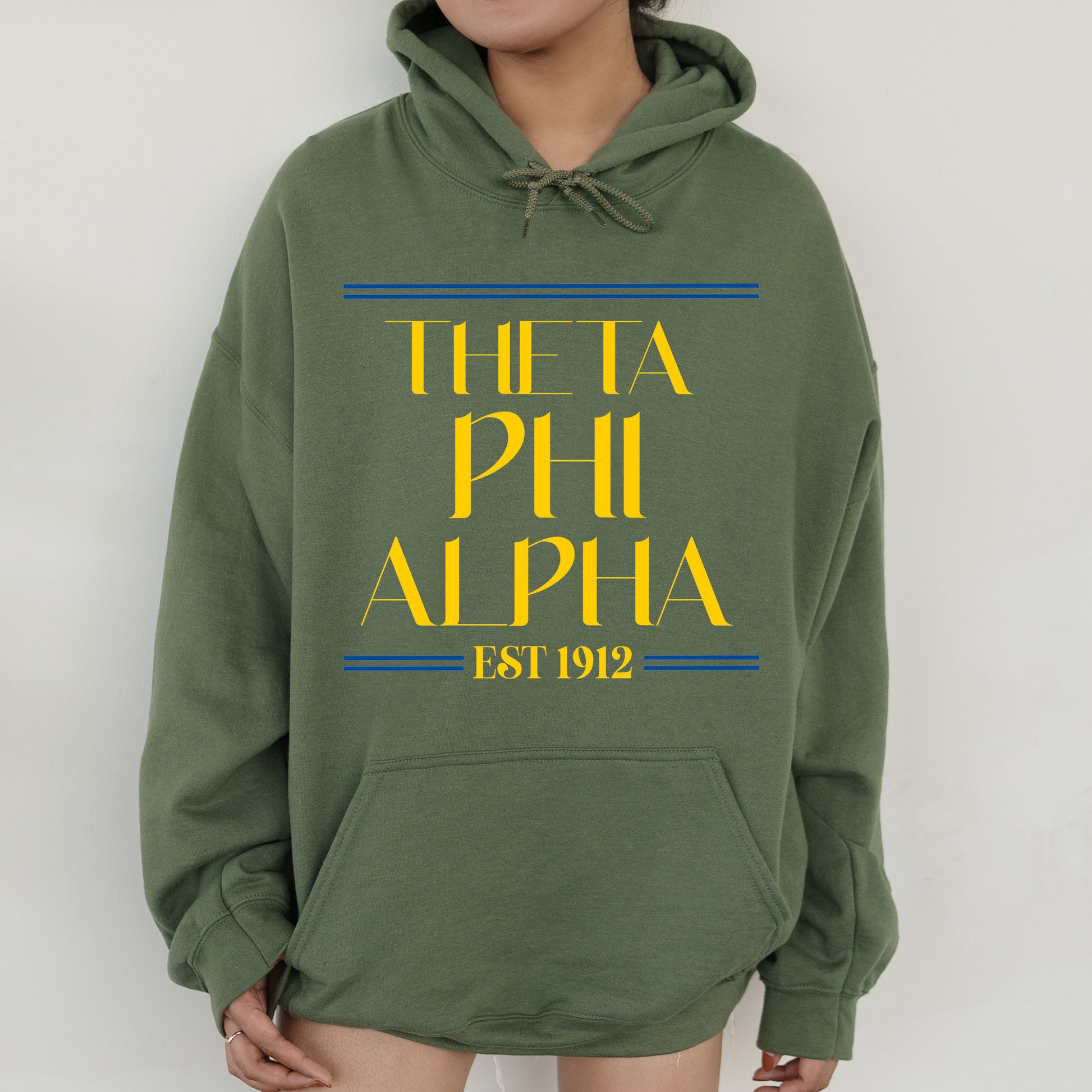 a person wearing a green hoodie with the words phi phi on it