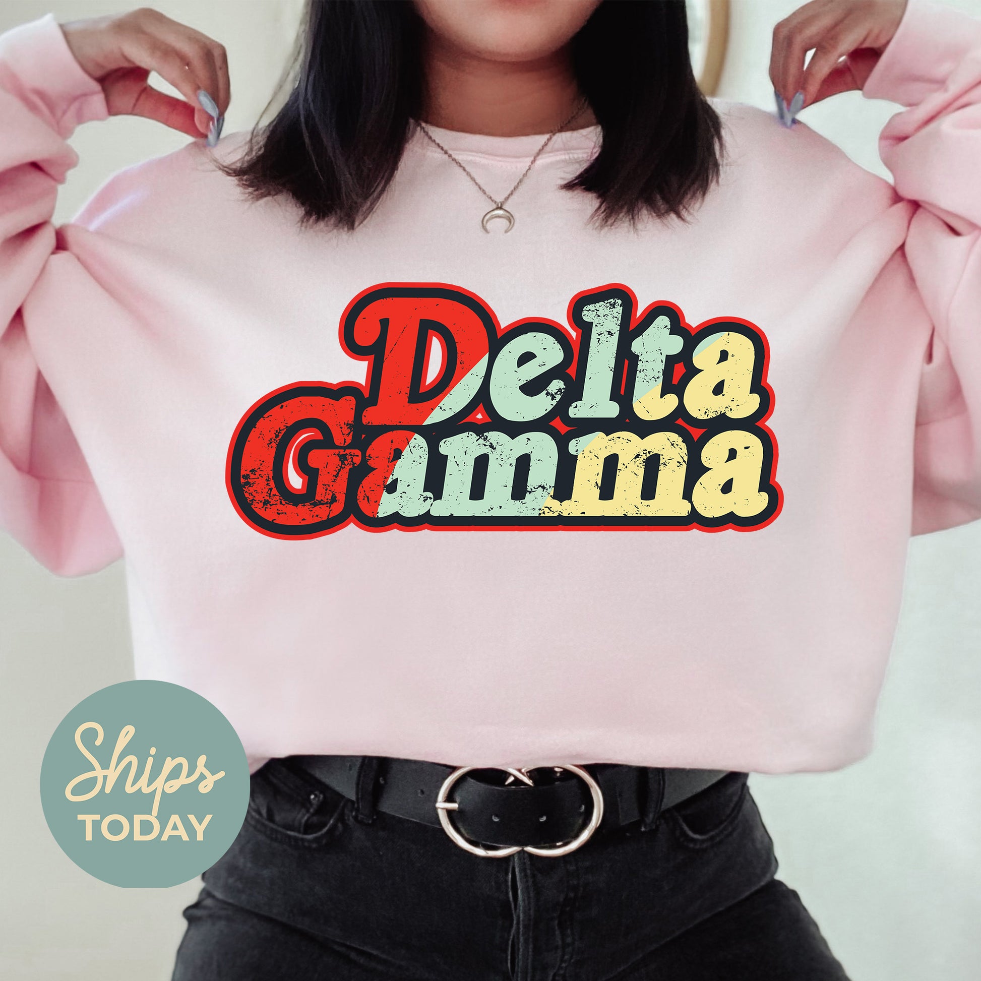 a woman wearing a pink sweatshirt that says delta gumma