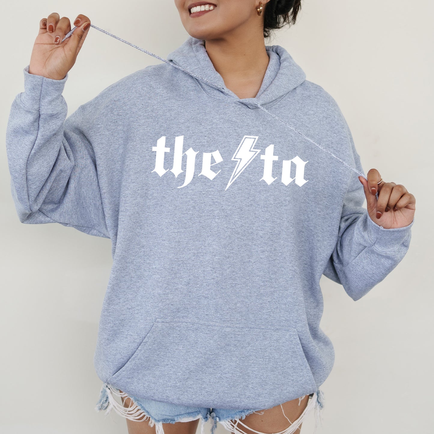 a woman wearing a blue hoodie with a lightning bolt on it