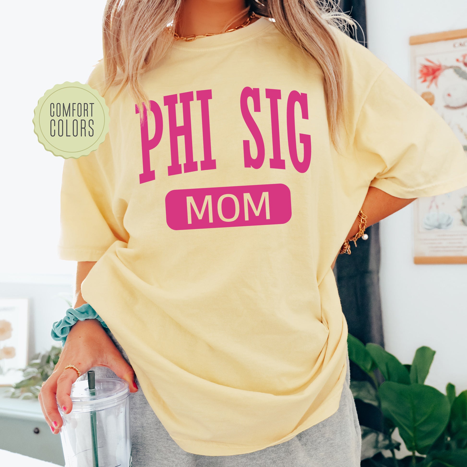 a woman in a yellow shirt is holding a blender