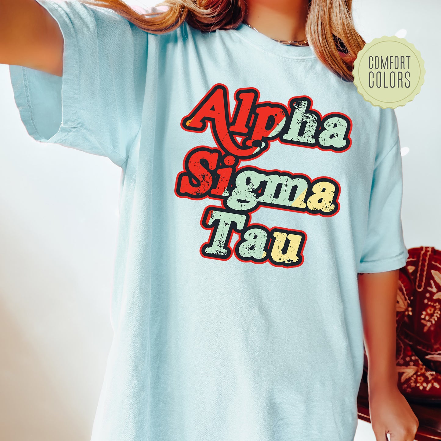 a woman wearing a light blue shirt that says ah ah sima tau