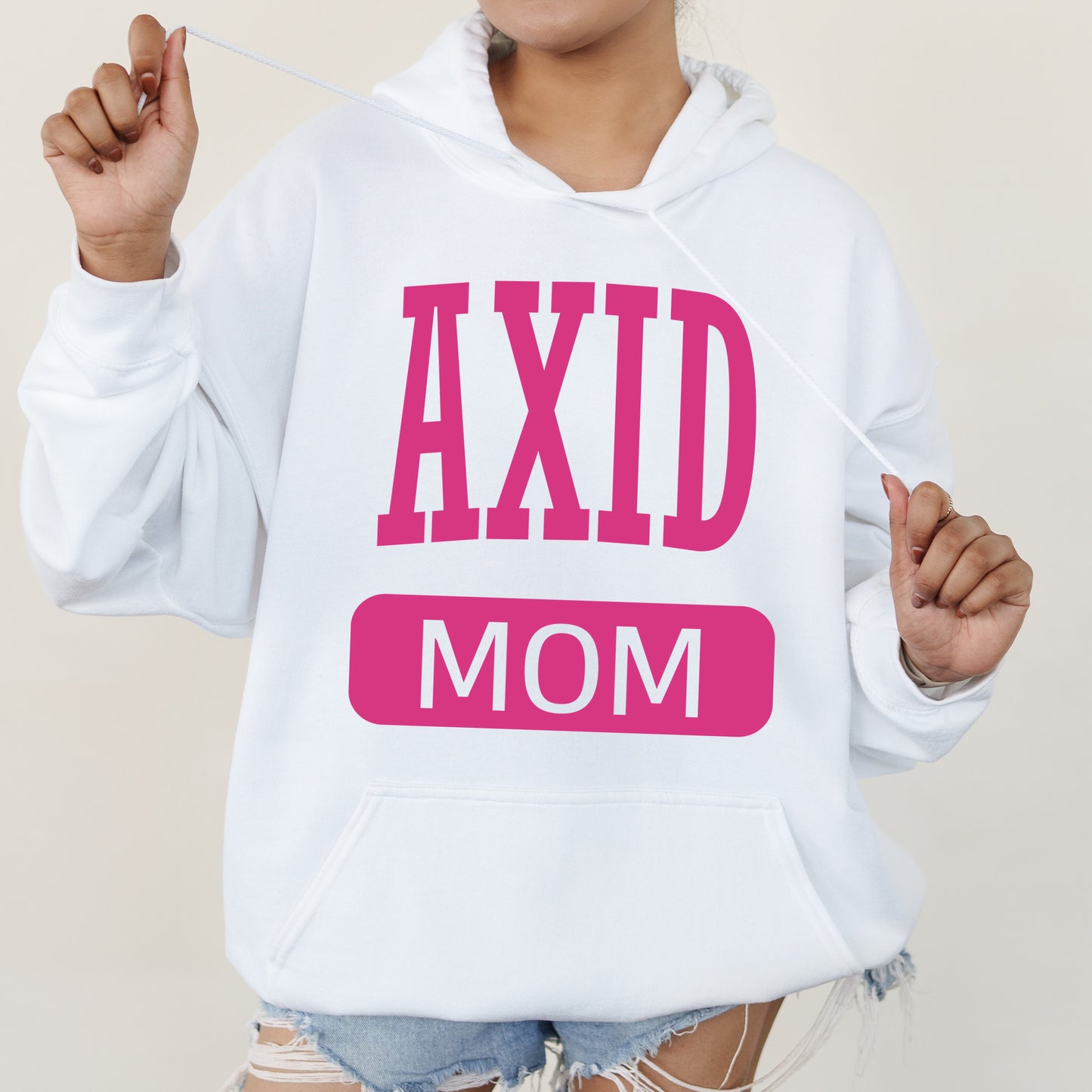 a woman wearing a hoodie that says axid mom