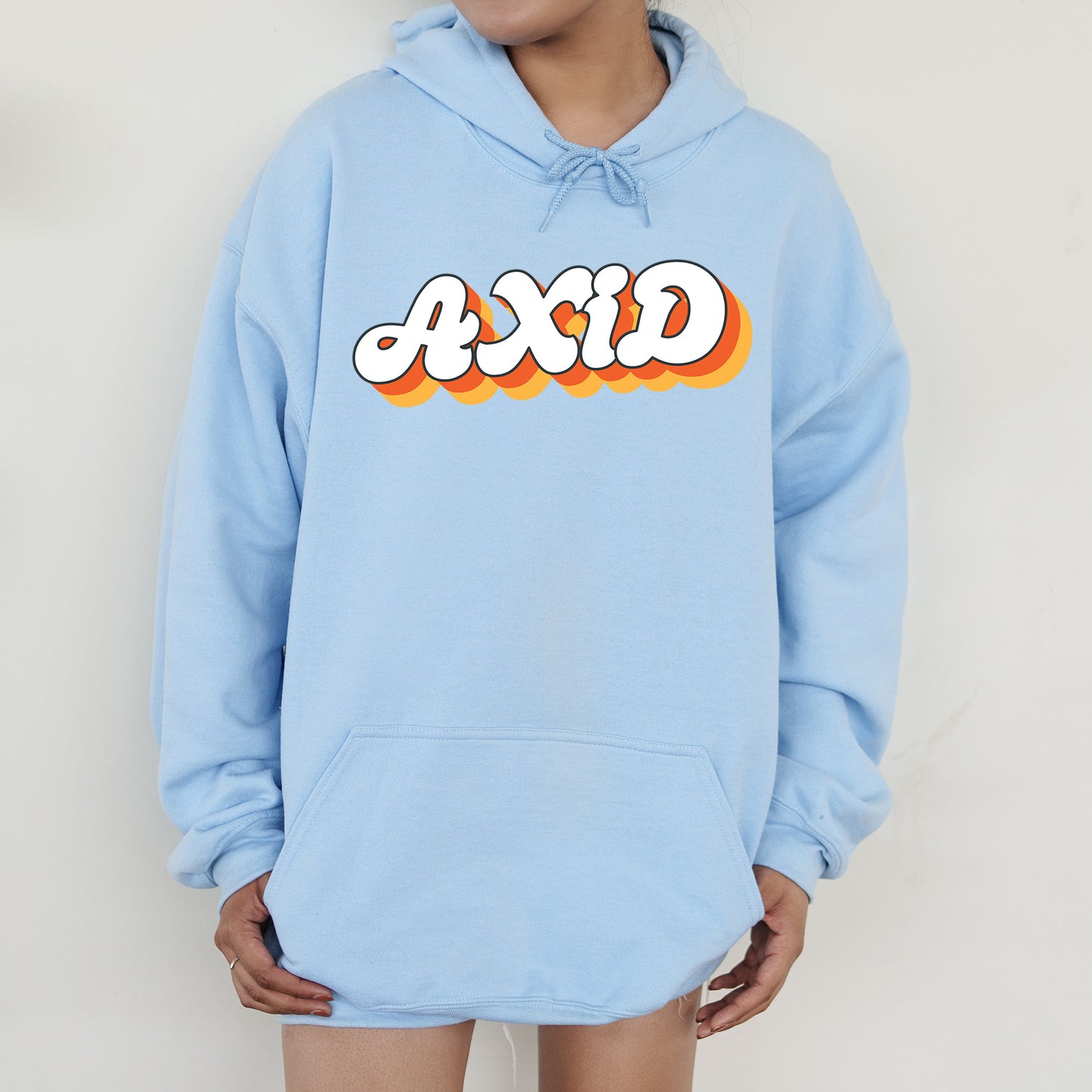 a person wearing a blue hoodie with the word acid printed on it