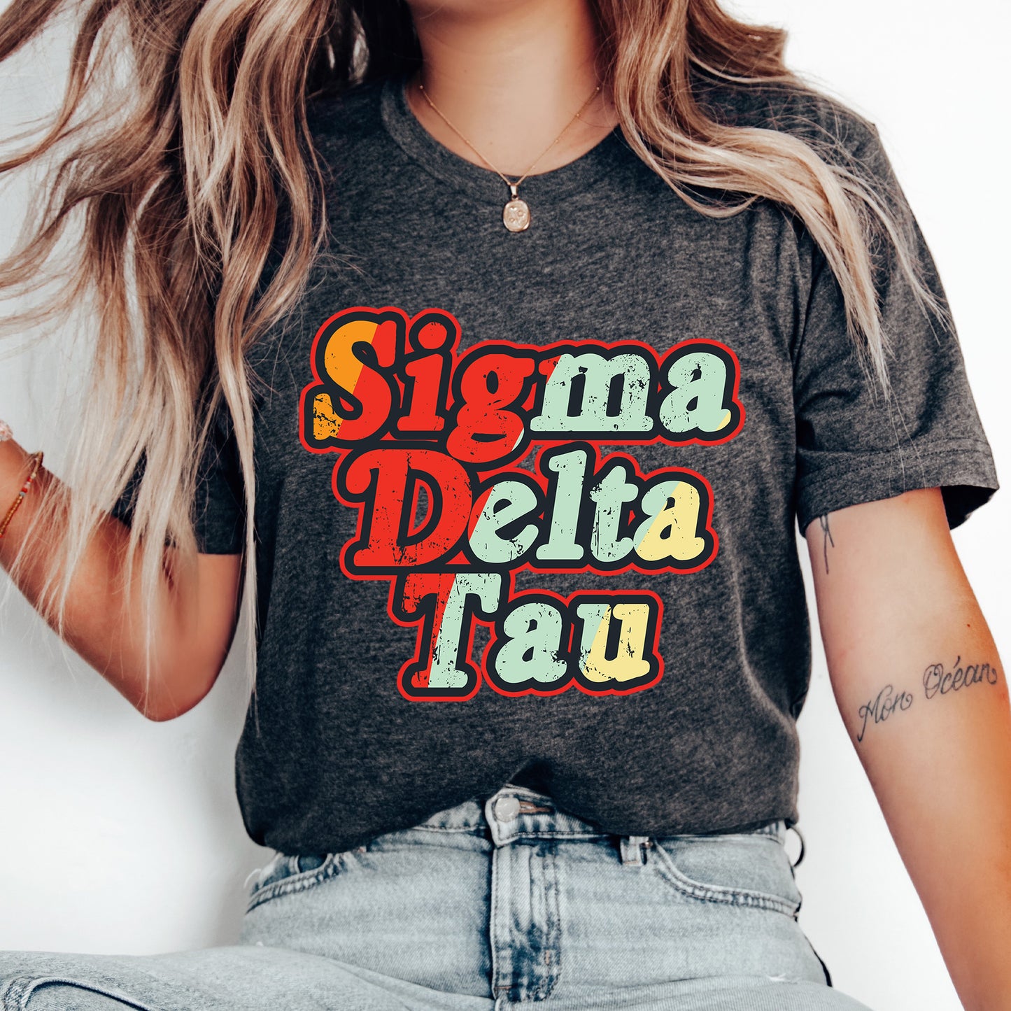 a woman with long hair wearing a shirt that says singma delta tau