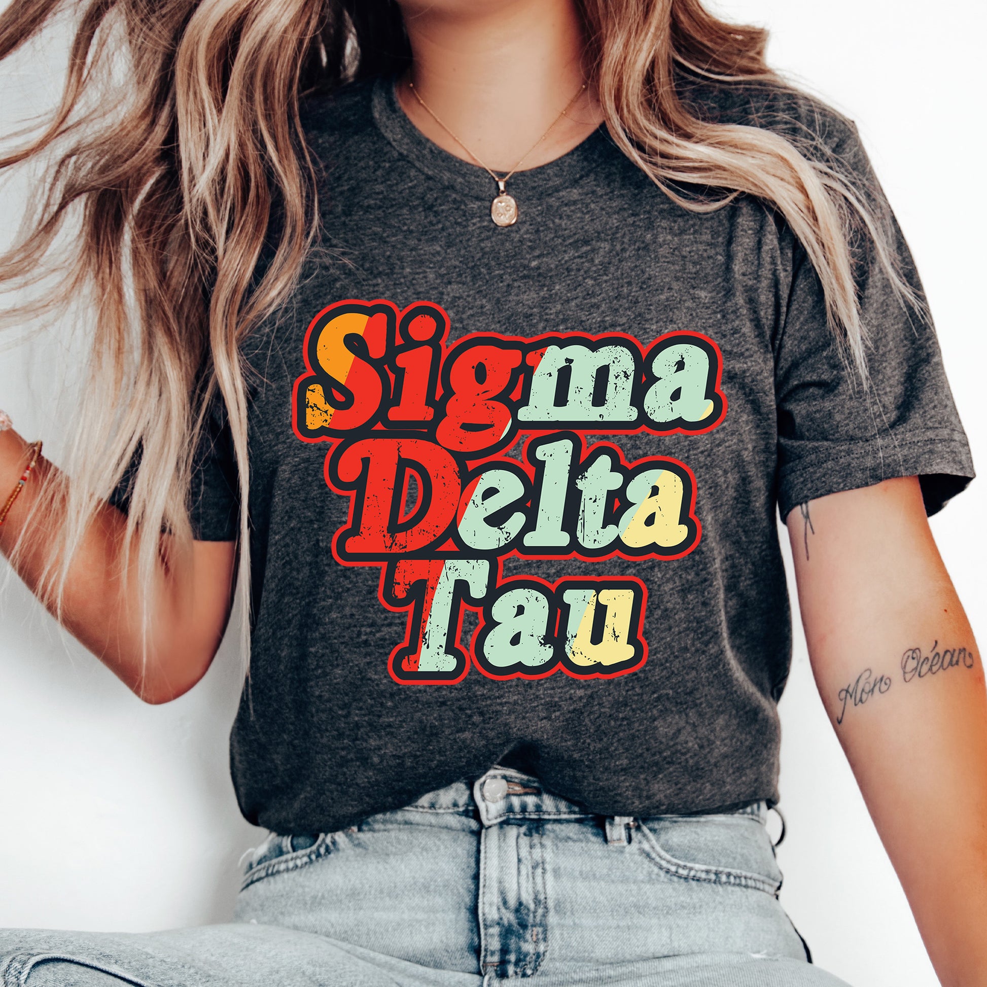 a woman with long hair wearing a shirt that says singma delta tau