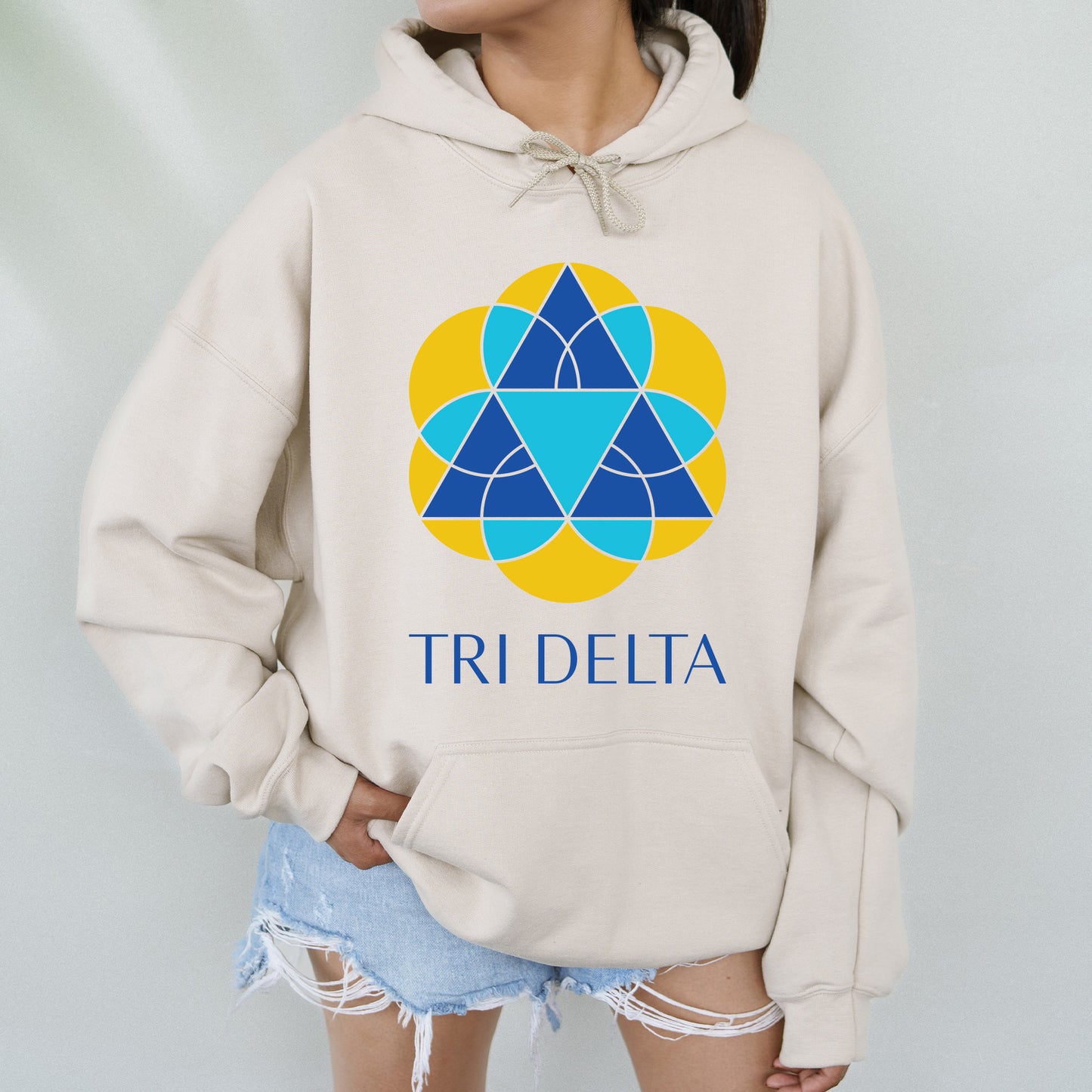 a woman wearing a sweatshirt with the tri delta logo on it