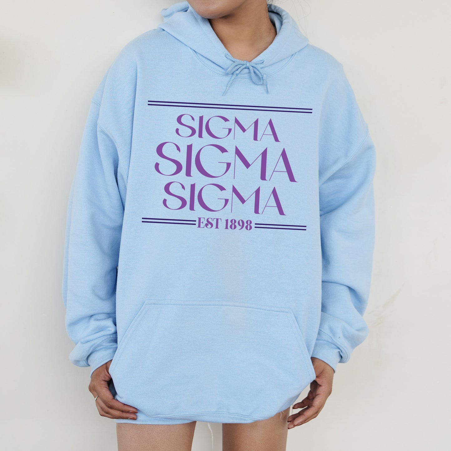 a woman wearing a blue sweatshirt with the words stigma stigma stigma on it