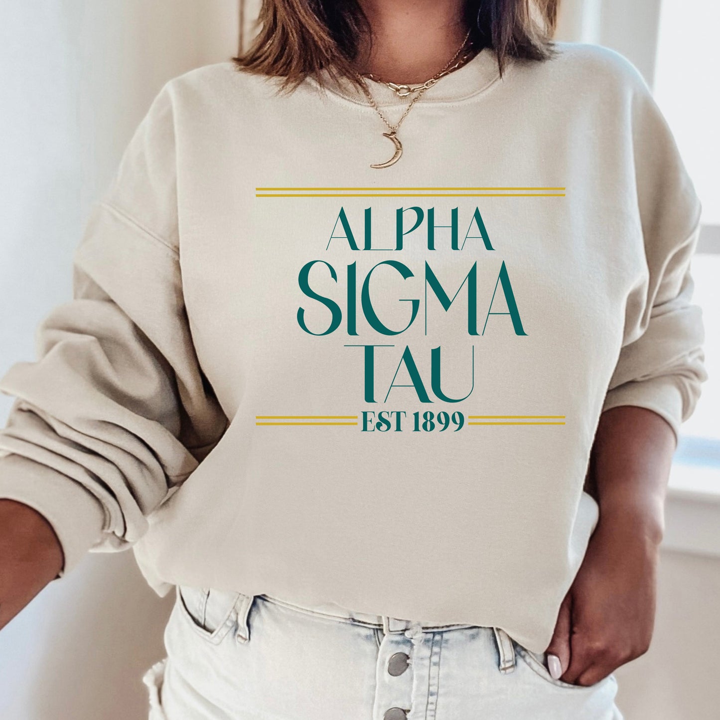 a woman wearing a sweatshirt that says,'alpha sigma tau est