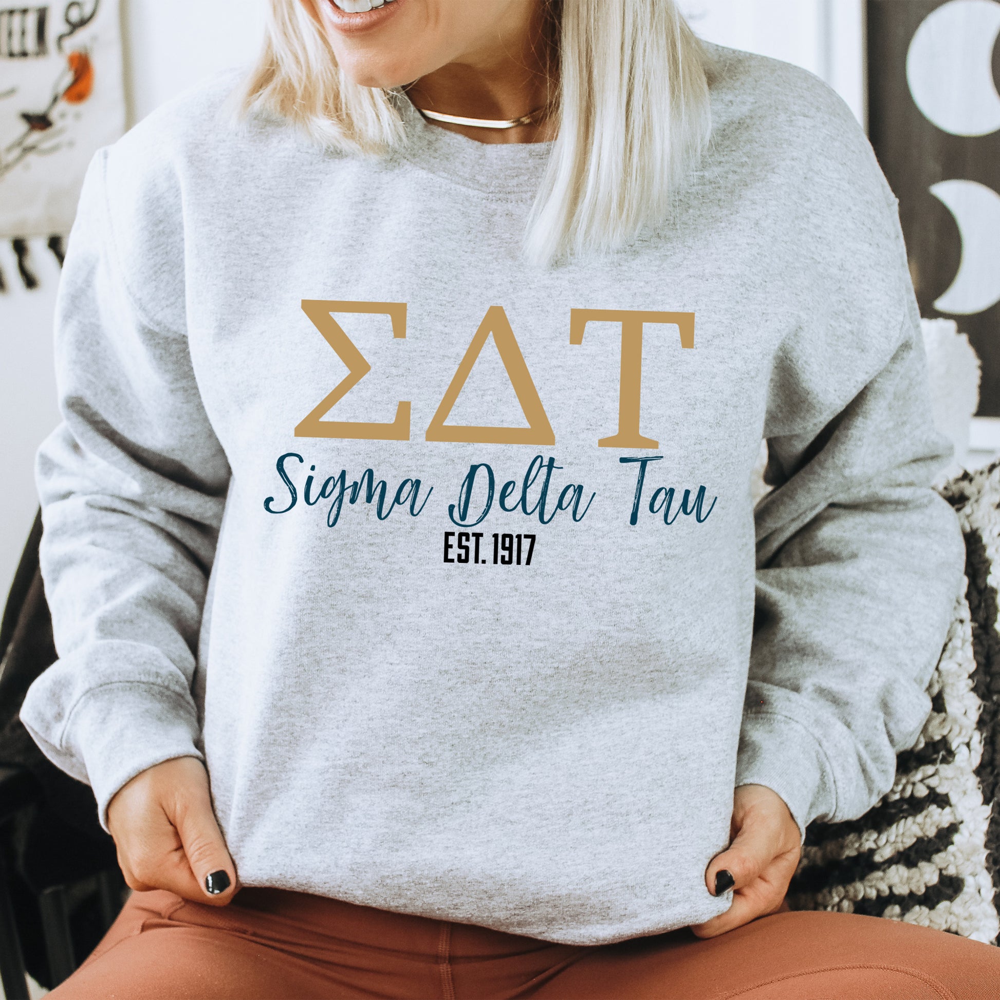a woman sitting on a chair wearing a sweatshirt