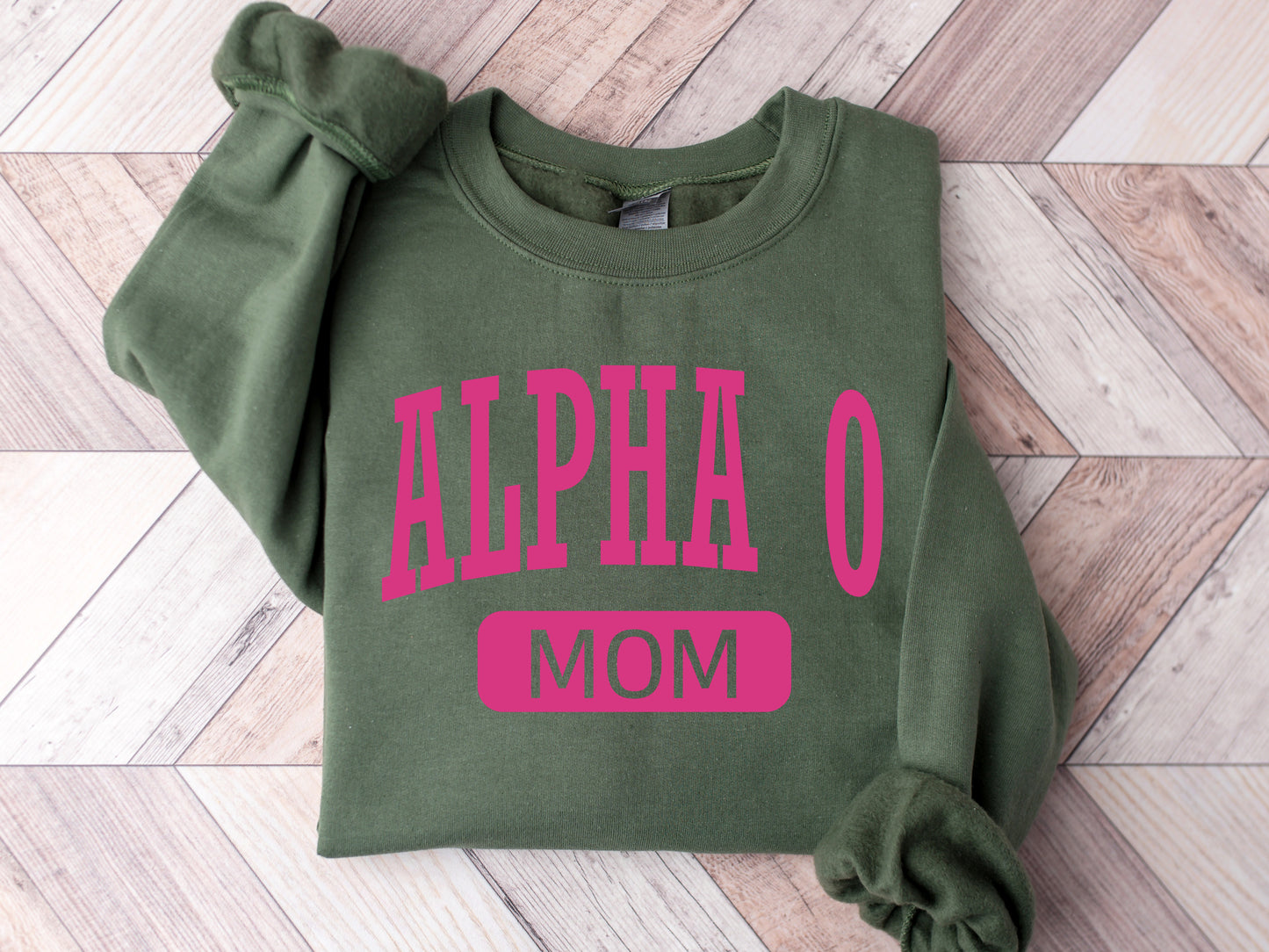 a green sweatshirt with pink letters on it