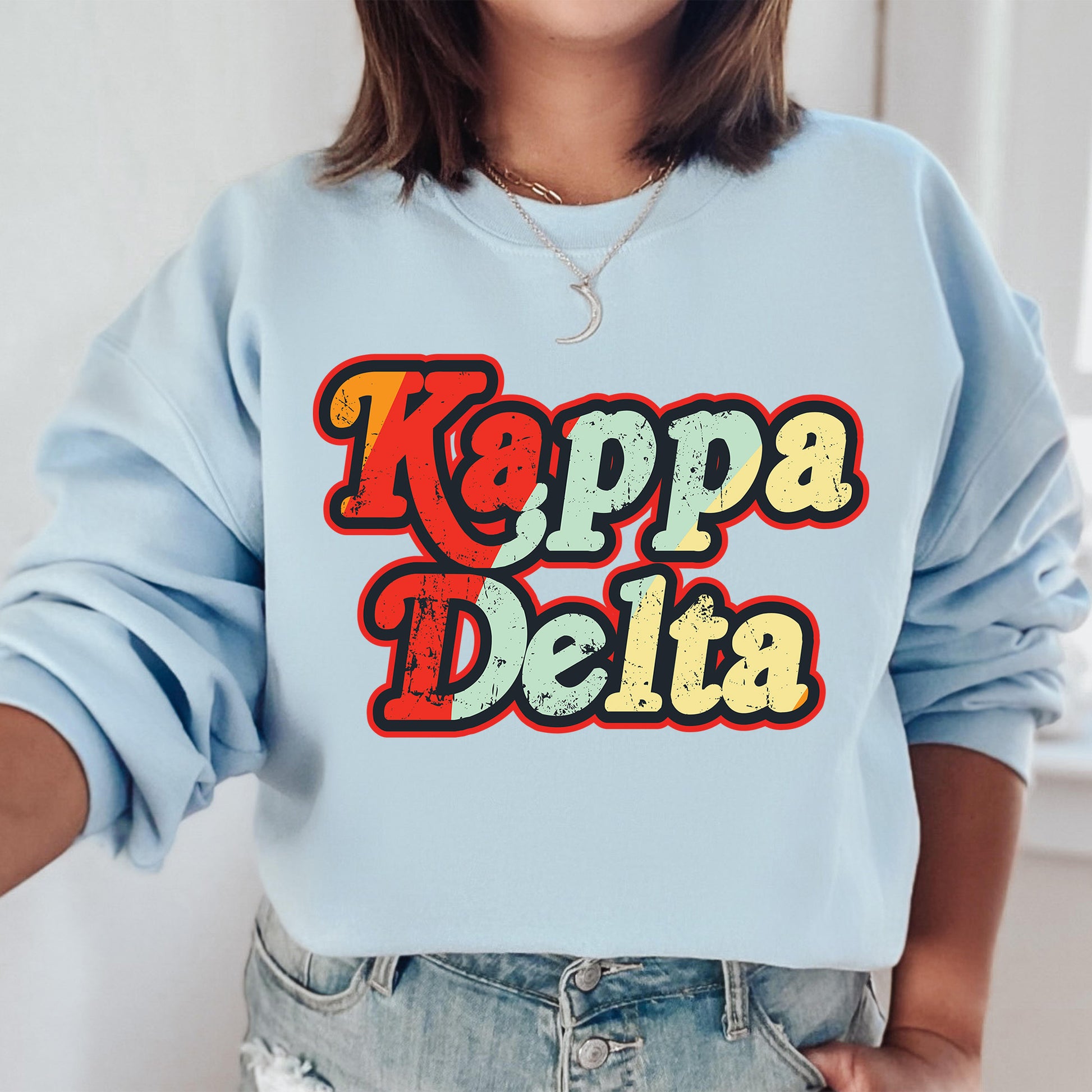 a woman wearing a sweatshirt that says kappa delta